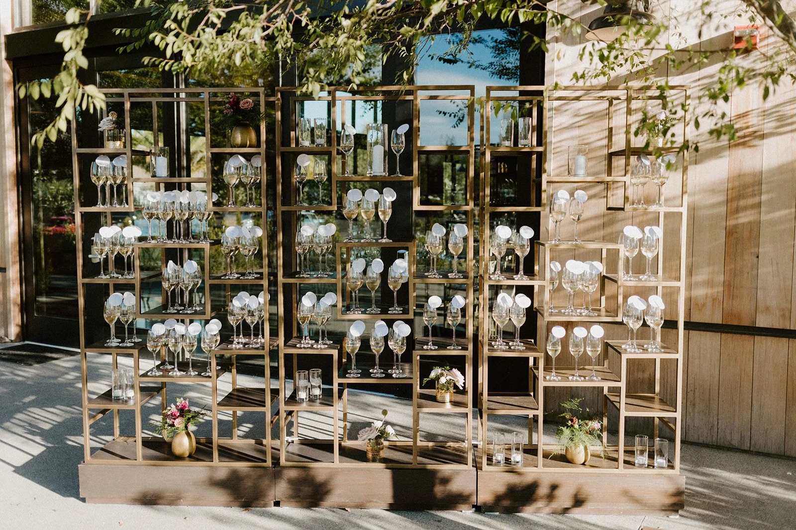 Modern gold shelf holding wine glasses image name: wedding-florist-boise-218