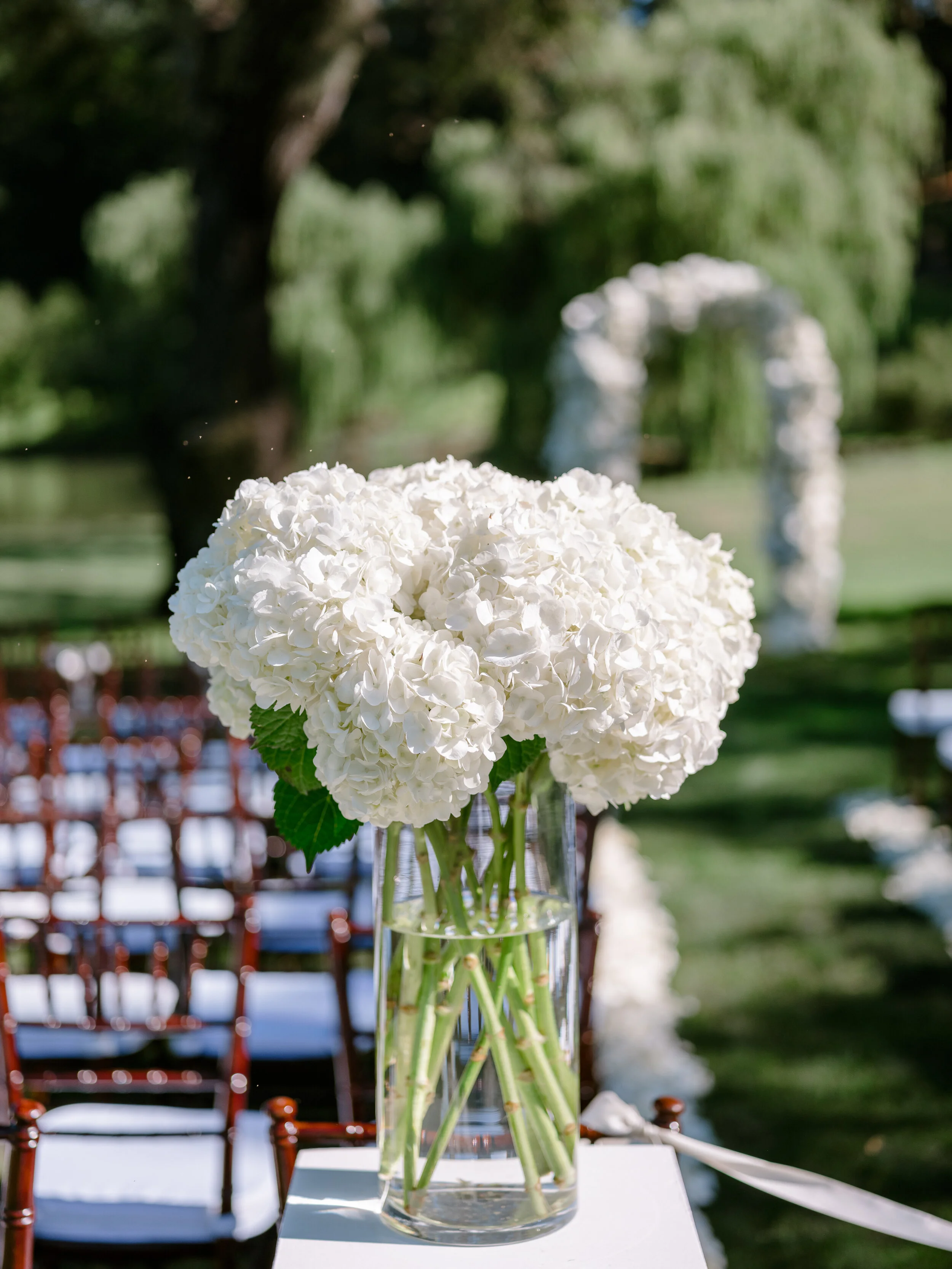 White hydrangeas in clear vase at San Francisco wedding image name: wedding-florist-boise-626