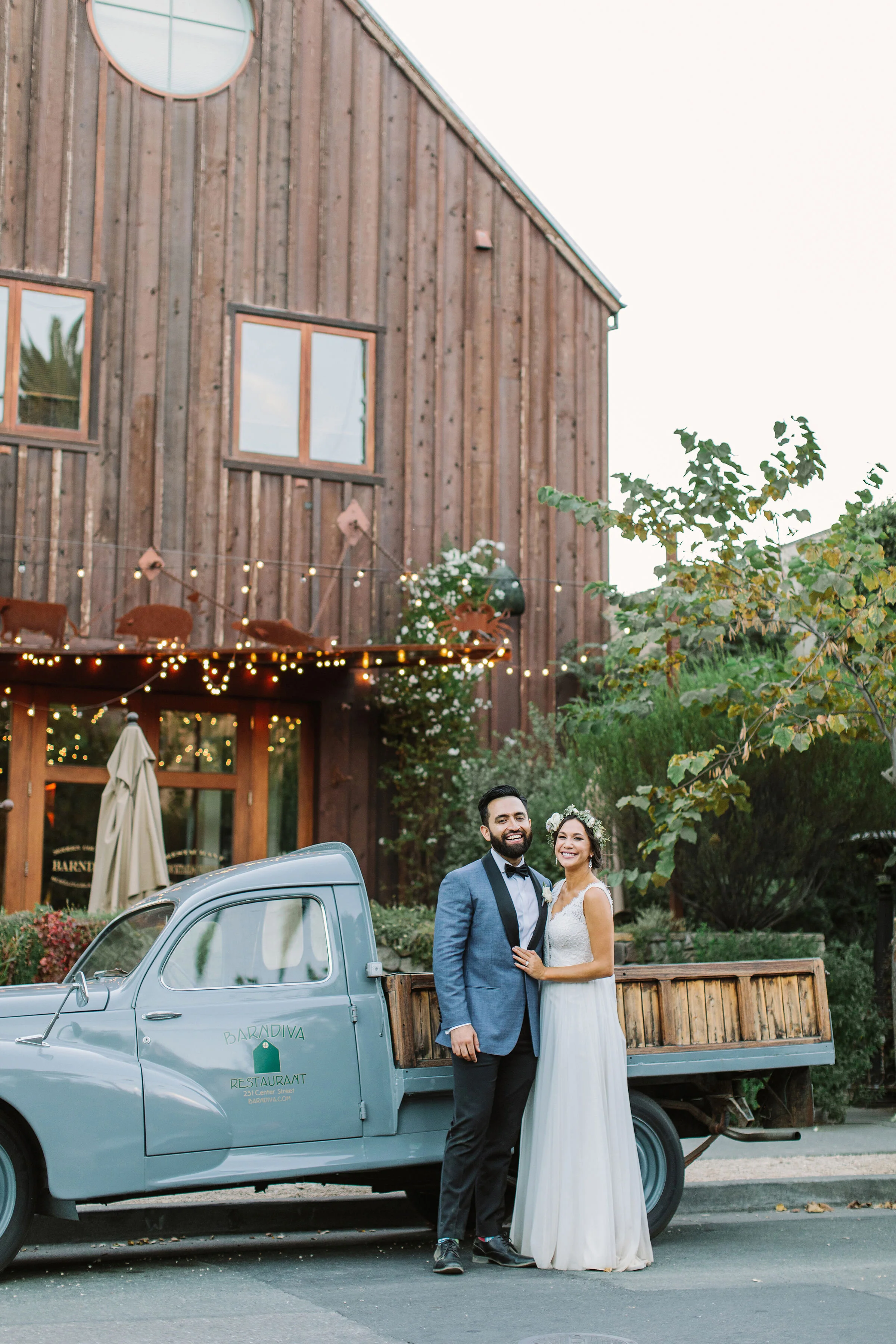 Couple pose before old farm truck in Sonoma County wedding image name: wedding-florist-boise-752