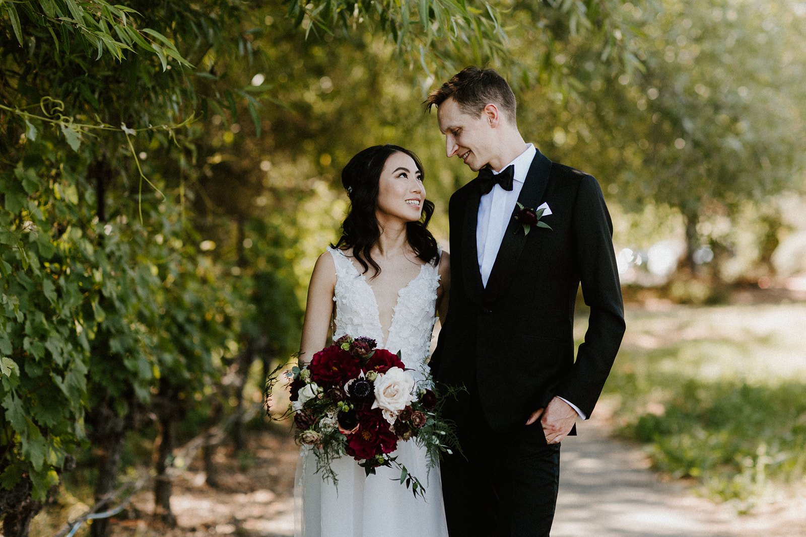 Wedding couple standing under tree autumn color bouqet image name: wedding-florist-boise-193