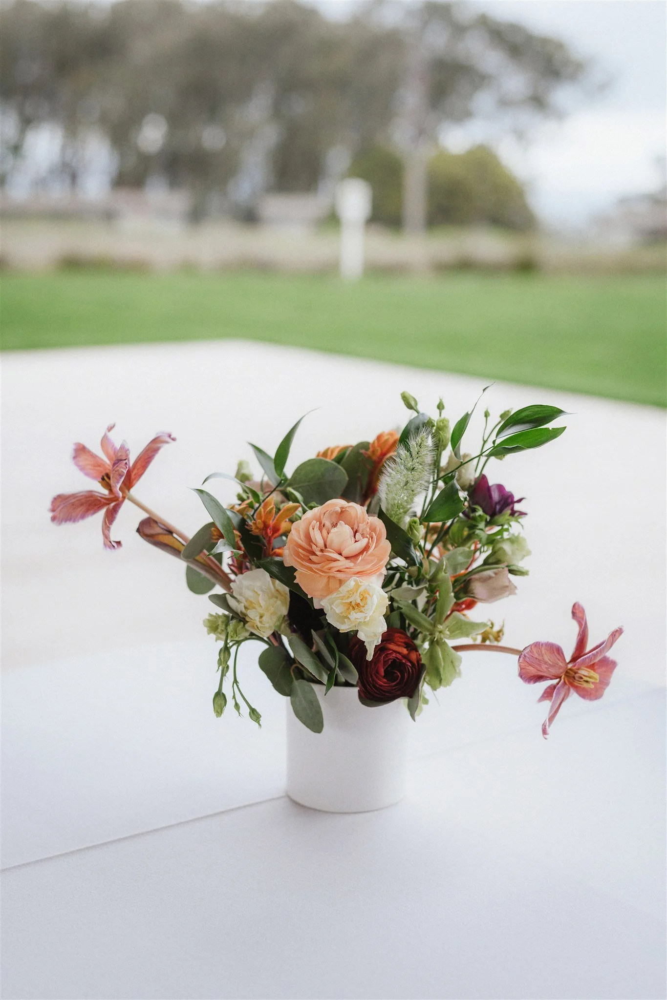 table setting bouquet lilies roses green leaves San Francisco California wedding. Image name: wedding-florist-boise-38