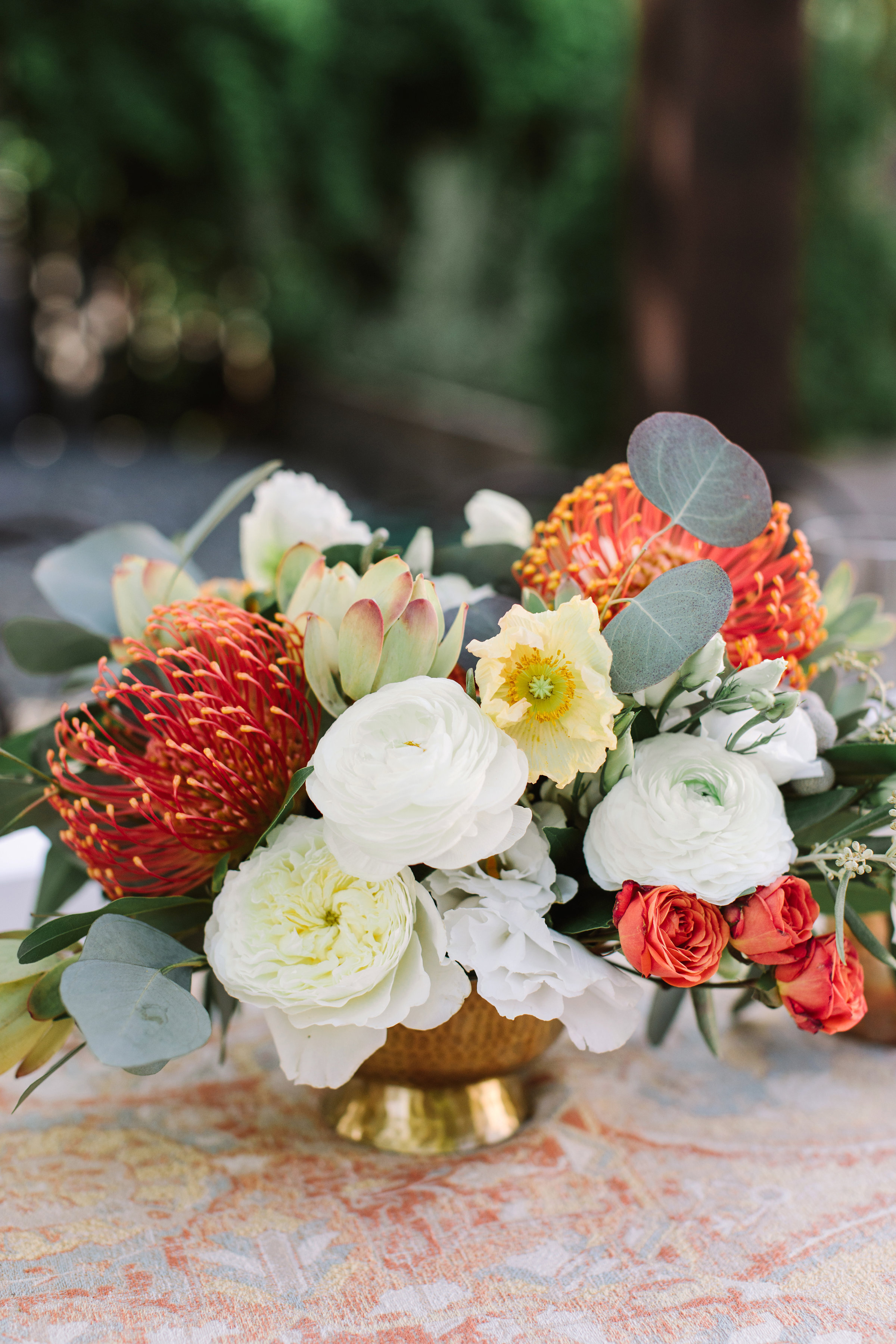 Protea whtie roses blush roses eucalyptus leaves in gold vase image name: wedding-florist-boise-782