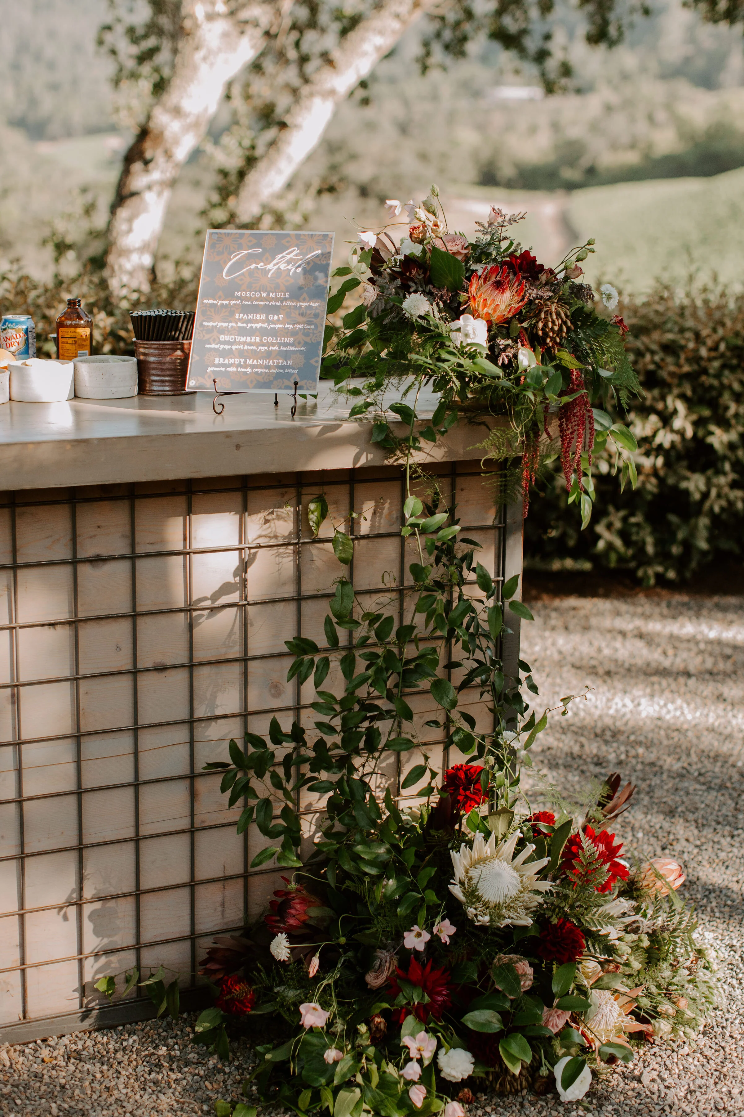 Floral arrangments with burgundy dahlias, protea, wine color dahlias at Promontory Estates image name: wedding-florist-boise-561