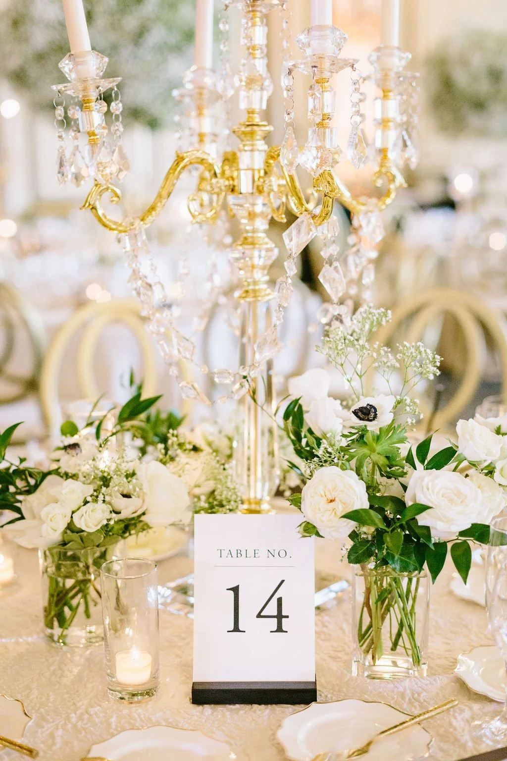 Golden candle opera vases filled white anemones white roses. Image name: wedding-florist-boise-68