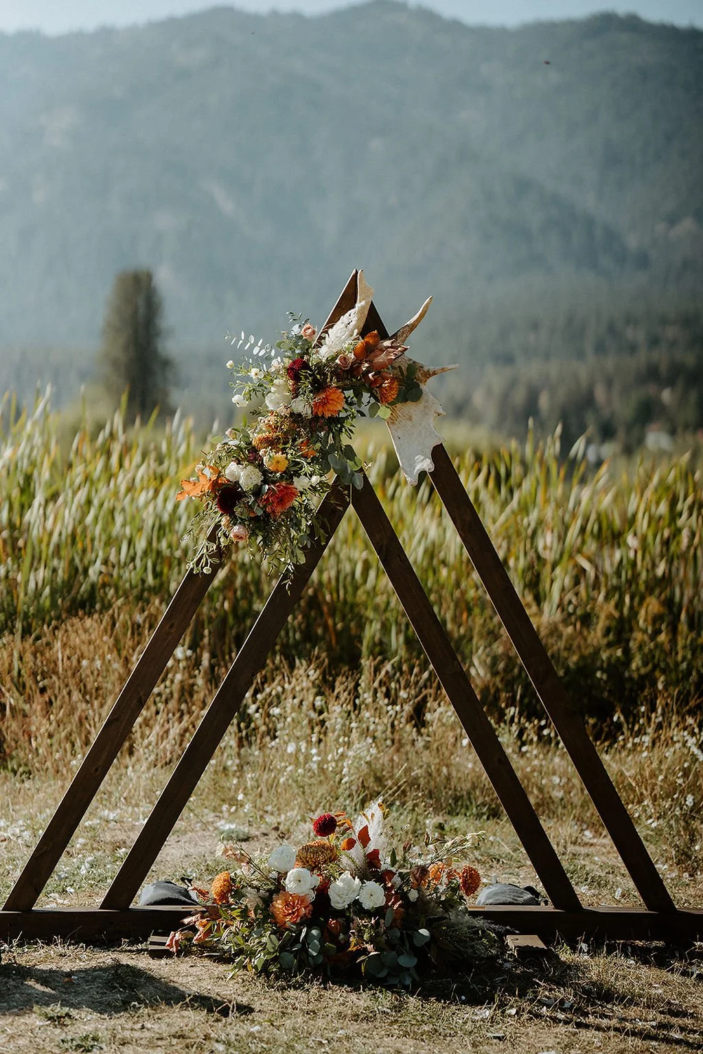 triangle arbor with fall flowers and mountains sixty chapel  image name: wedding-florist-boise-852