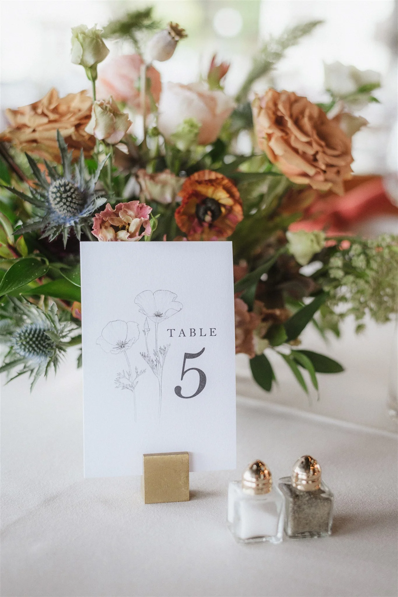 Table bouquet of various flowers including roses, lilies, ranunculus. Image name: wedding-florist-boise-45