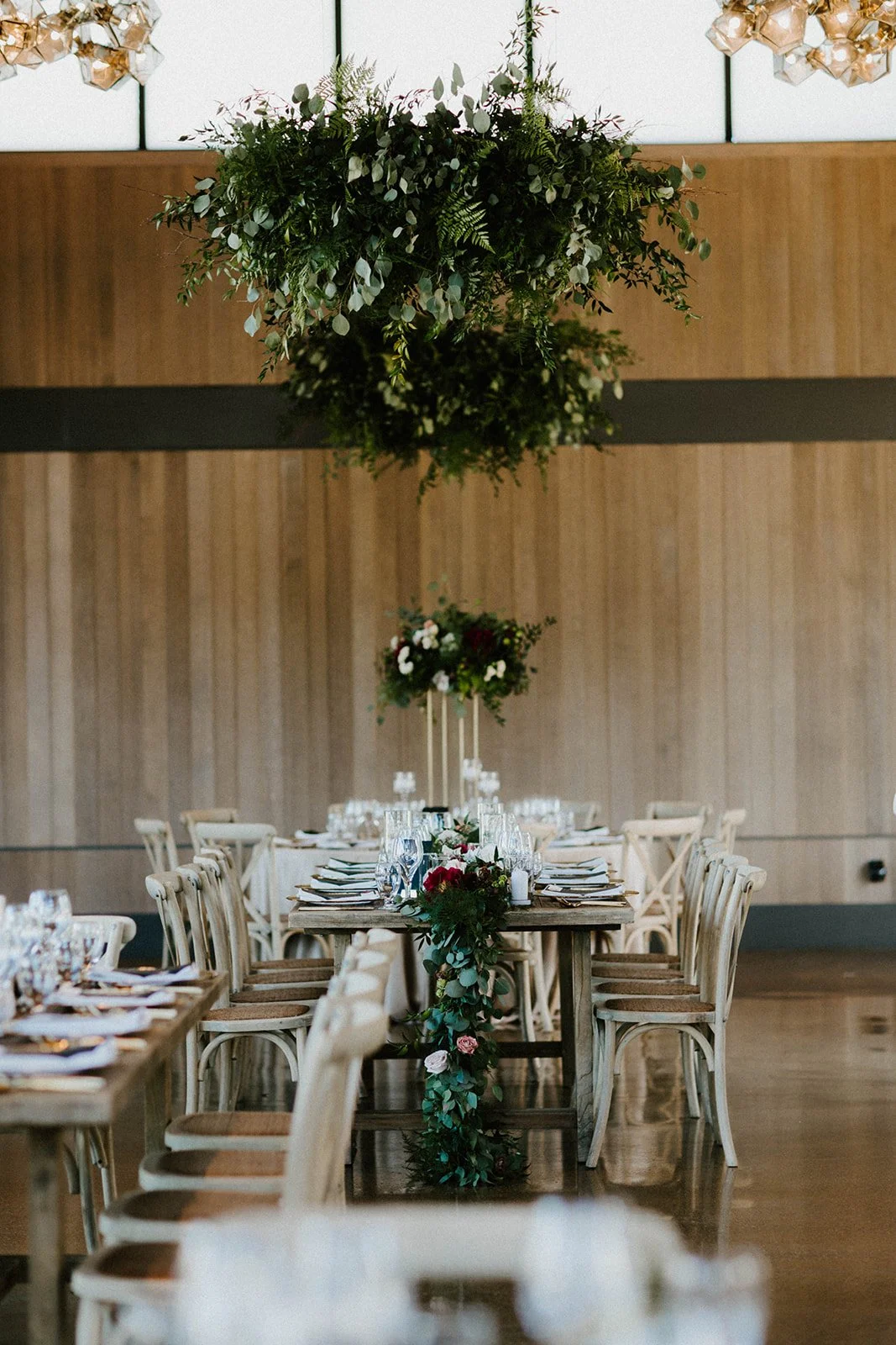 Hanging fern plants inside wedding hall image name: wedding-florist-boise-201