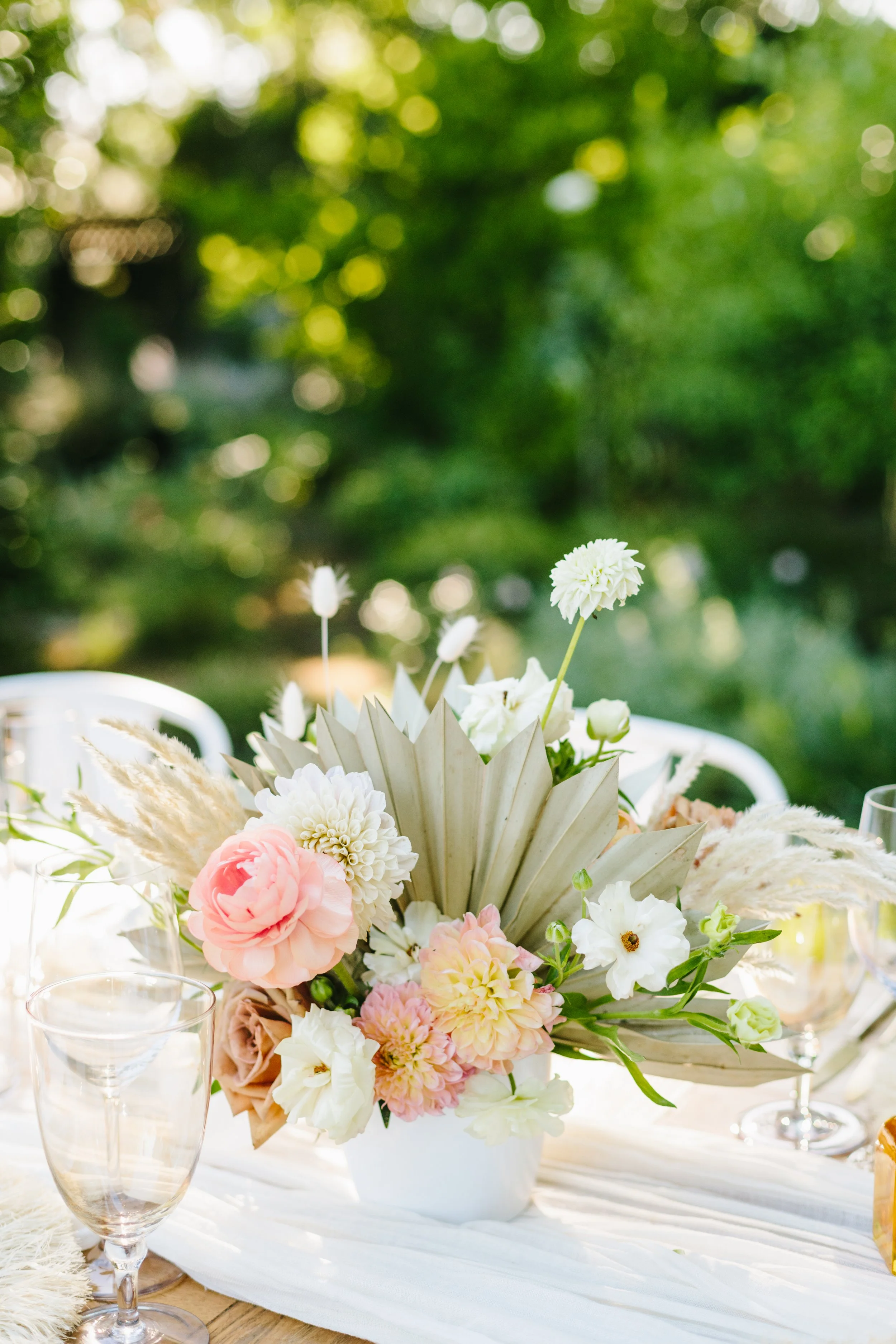 Table floral arrangement of wild white roses, pink dahlias, pink peonies. Image name: wedding-florist-boise-171