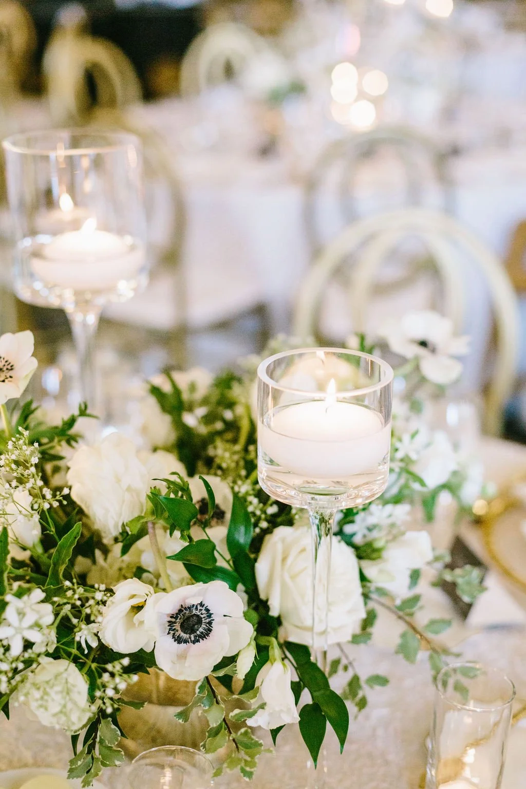 Floral arrangement white anemones, roses, baby's breath white candle. Image name: wedding-florist-boise-64