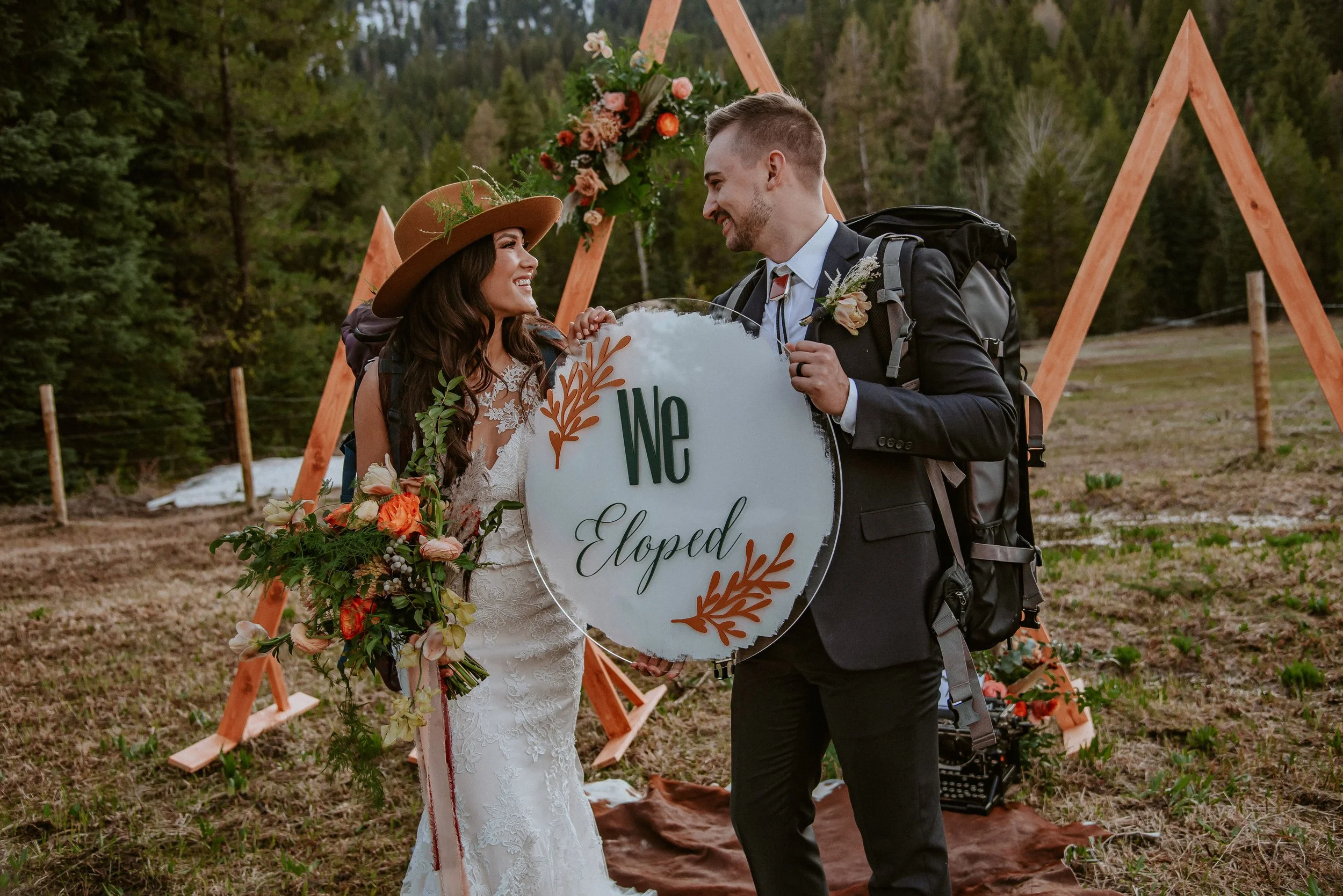 Couple holds sign that says "We Eloped" Bay Area CA . Image name: wedding-florist-boise-110