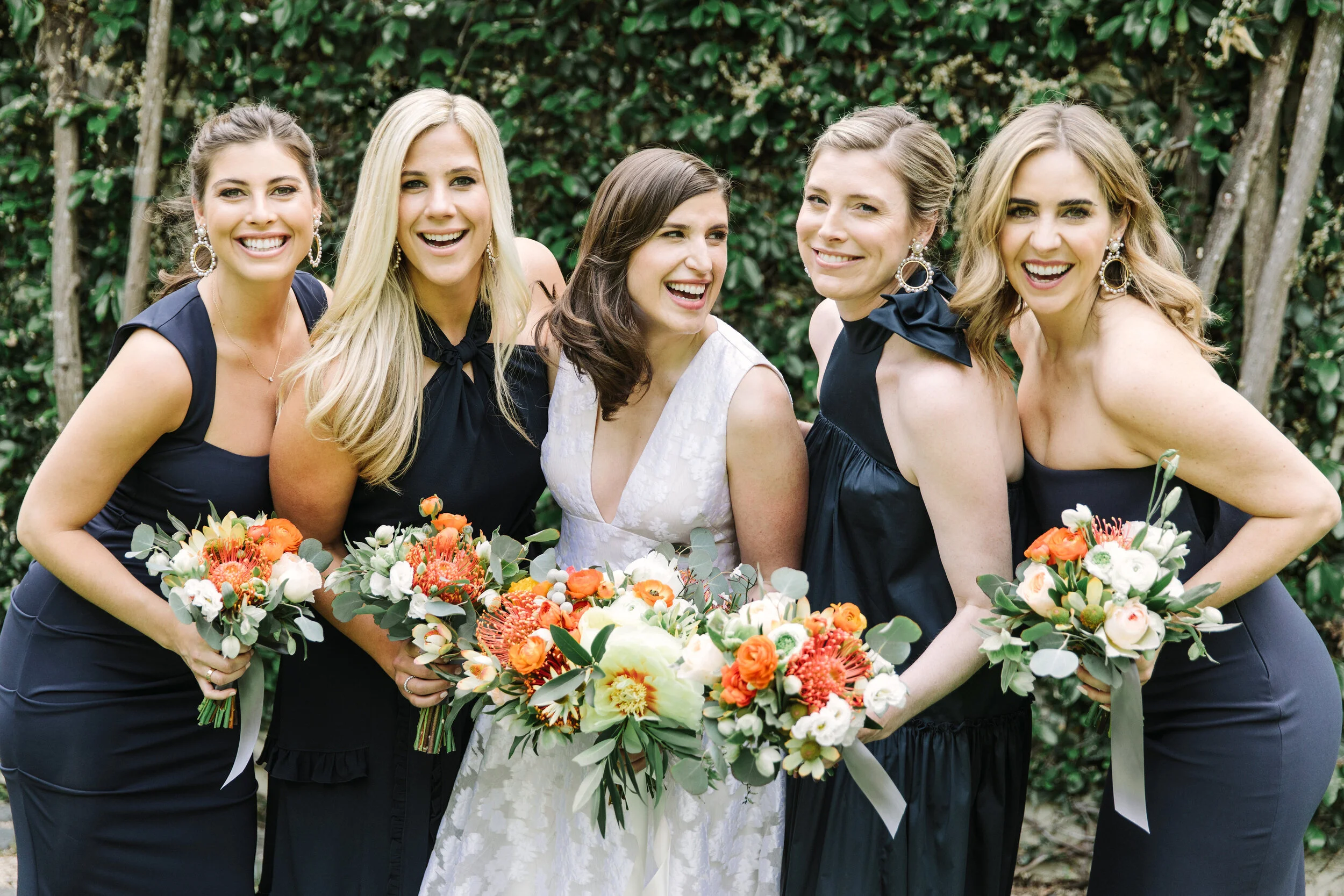 Bridal party with bouquets with white roses protea poppies eucalyptus leaves image name: wedding-florist-boise-786