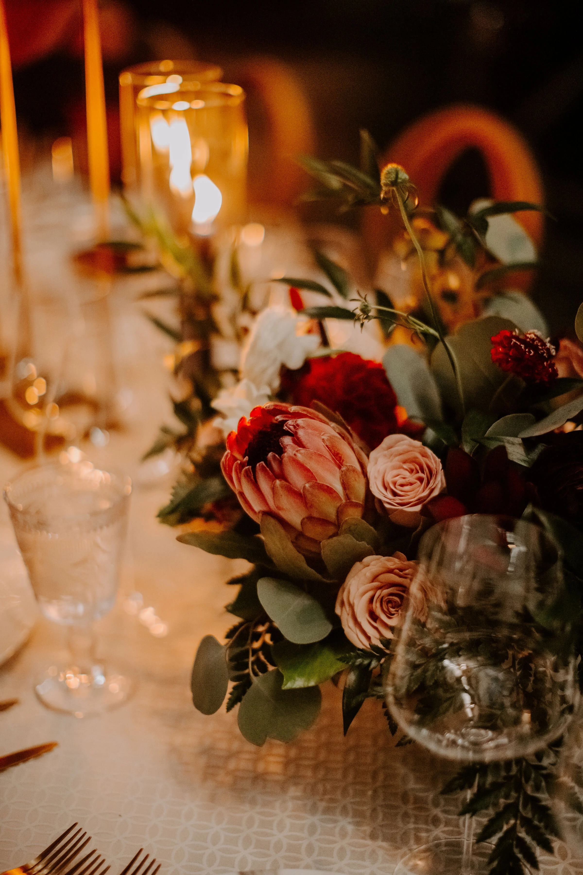 Floral arrangement with protea blush roses pink roses burgundy dahlias image name: wedding-florist-boise-552