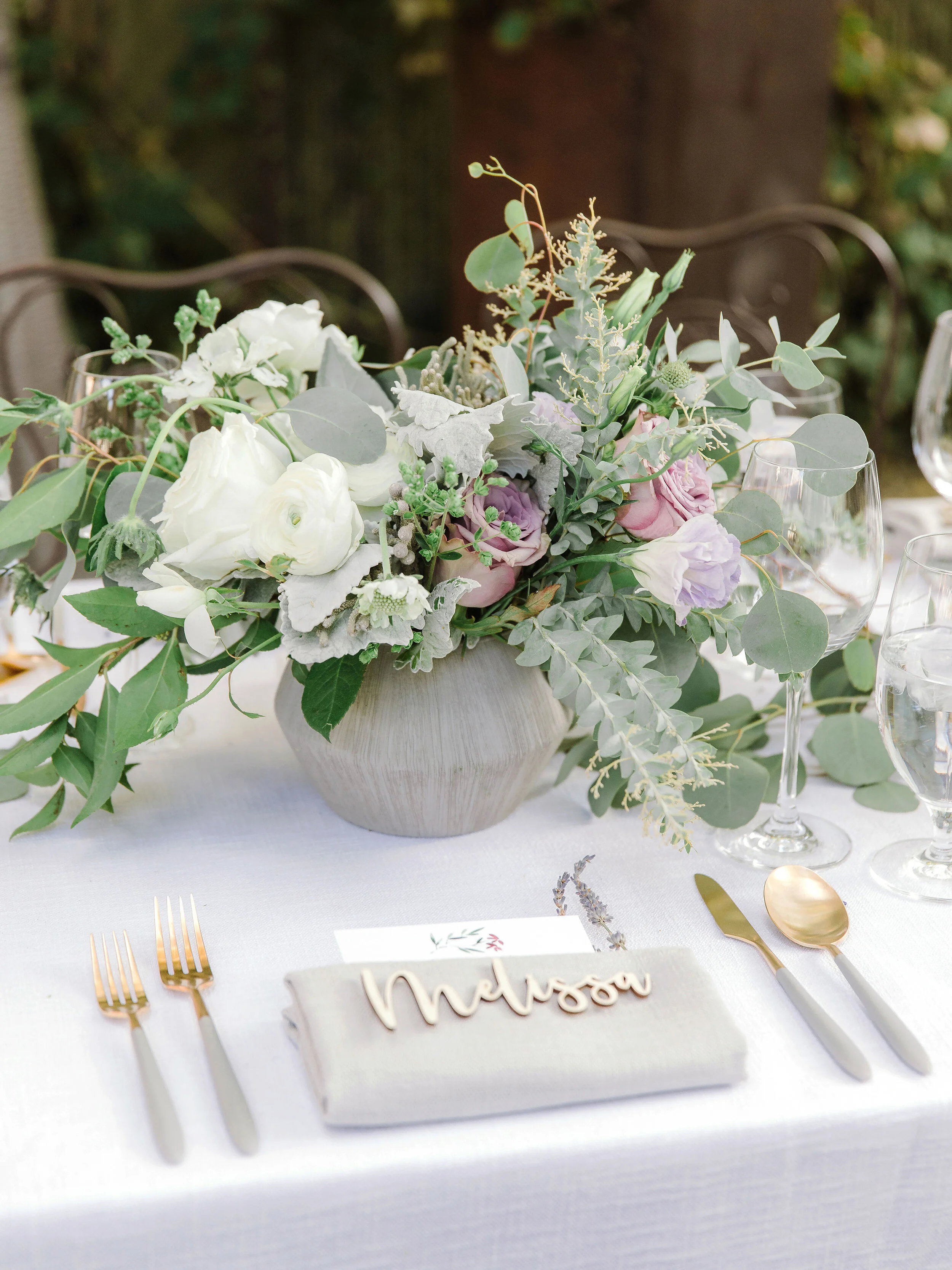 White roses lavender roses eucalyptus leaves sit in vase for Sonoma wedding image name: wedding-florist-boise-756