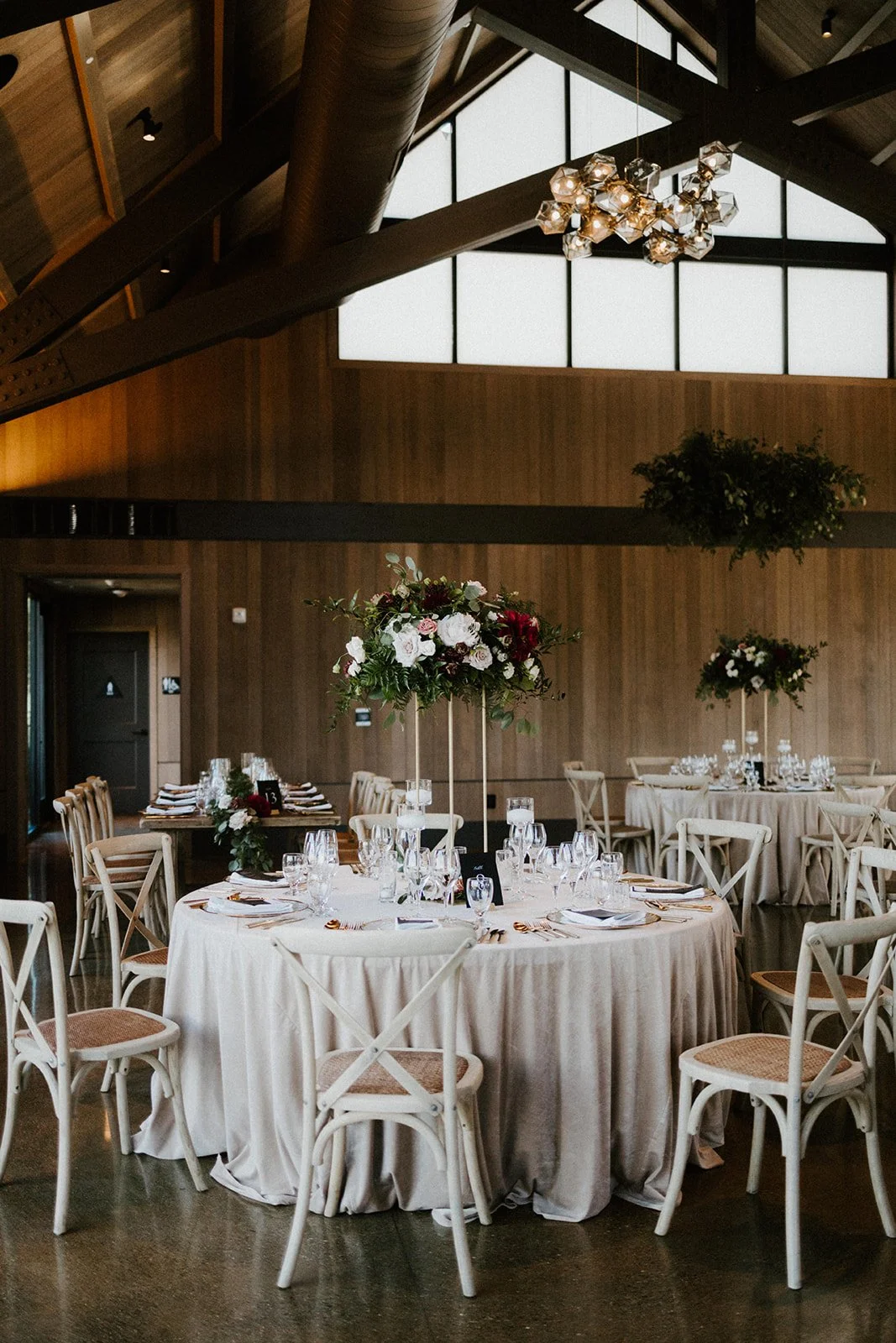 White table cloth tall floral centerpieces white roses indoor wedding reception image name: wedding-florist-boise-213