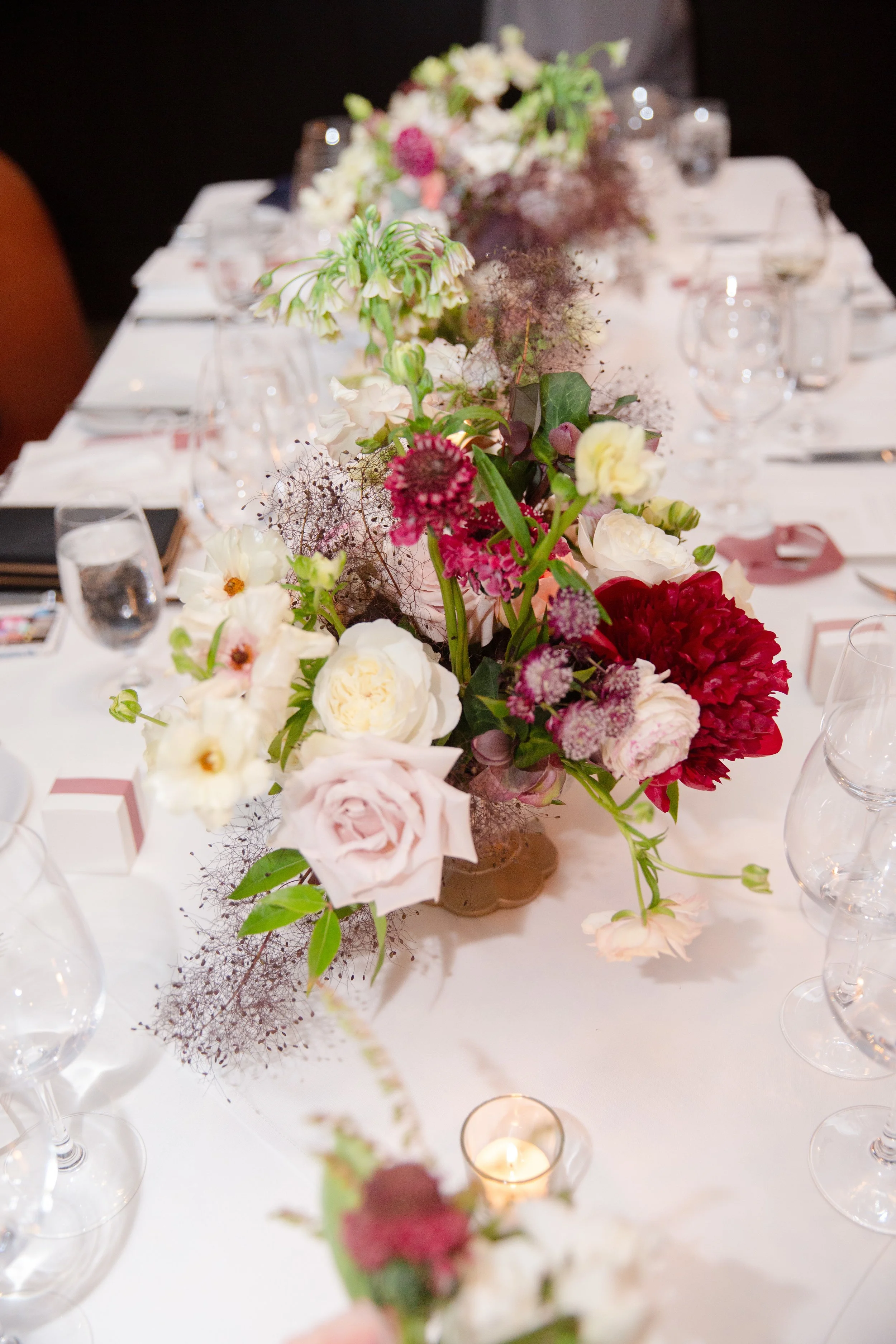 Reception table florals of red roses red peonies pink roses white roses image name: wedding-florist-boise-417