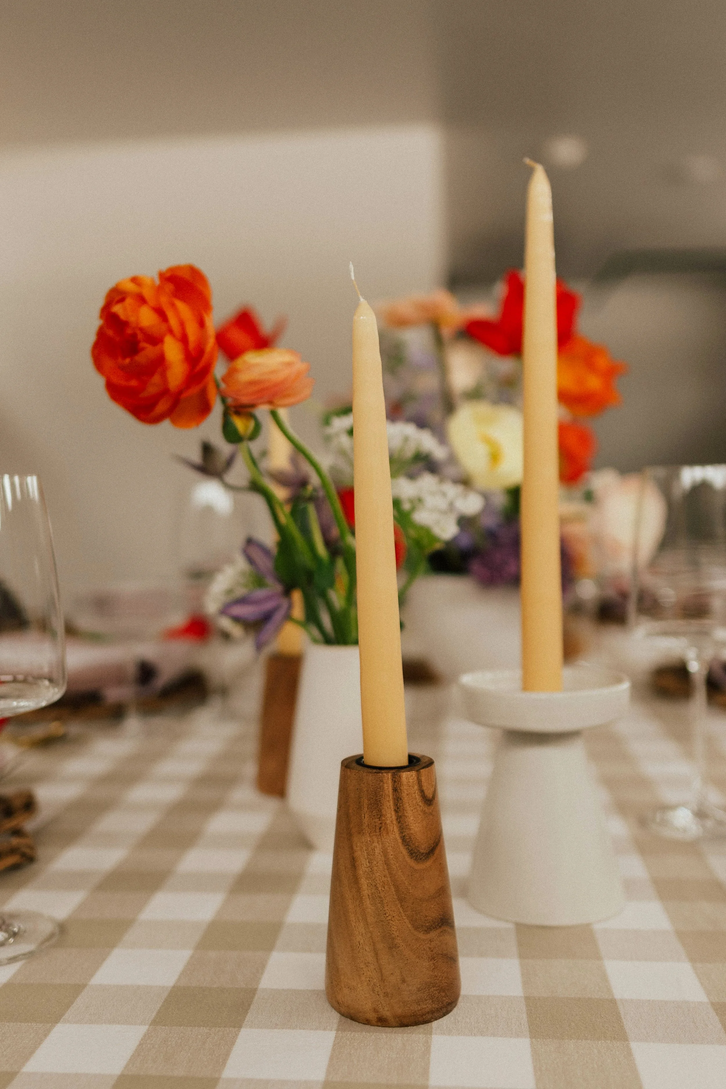 white candle in front of red peonies blush ranunculus image name: wedding-florist-boise-261