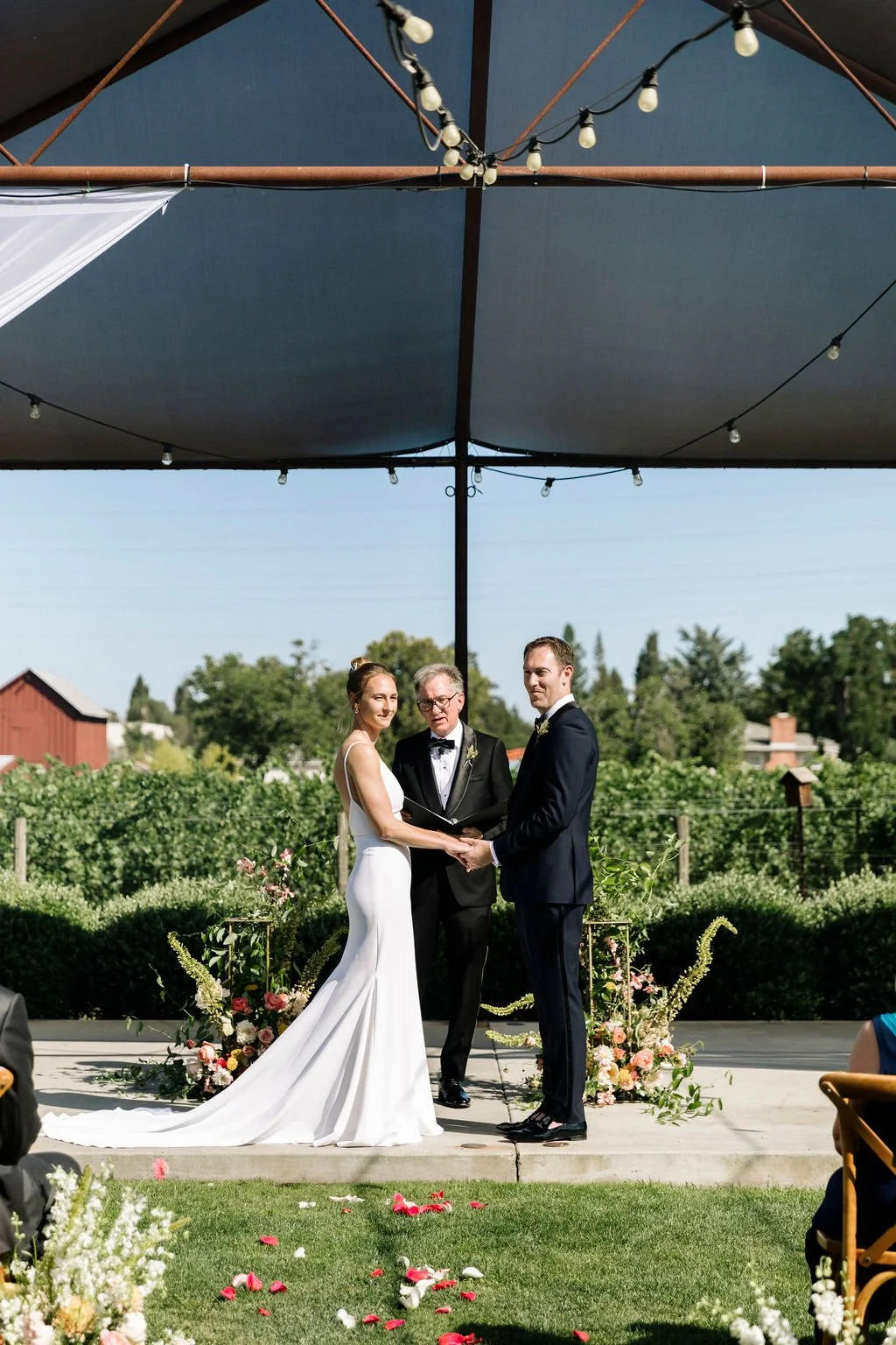 Bride groom standing under pergola San Francisco farm wedding. Image name: wedding-florist-boise-86
