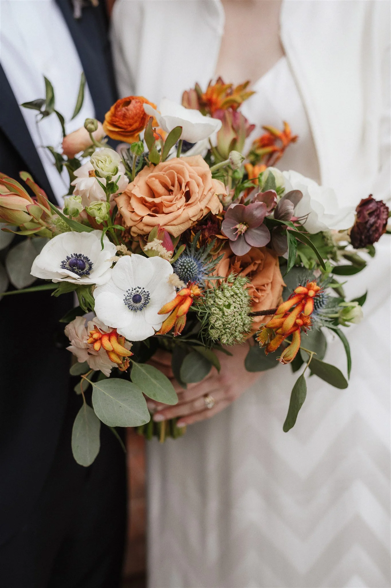 Bride's bouquet earthy-tone flowers anemones, roses, lilies ranunculus San Francisco CA. Image name: wedding-florist-boise-36