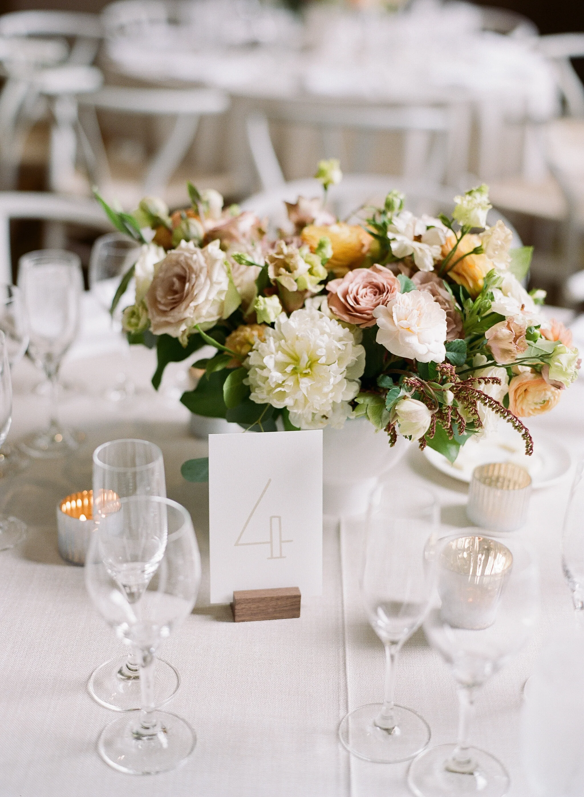 Neutral tone floral arrangement at reception white roses white dahlias blush roses image name: wedding-florist-boise-609