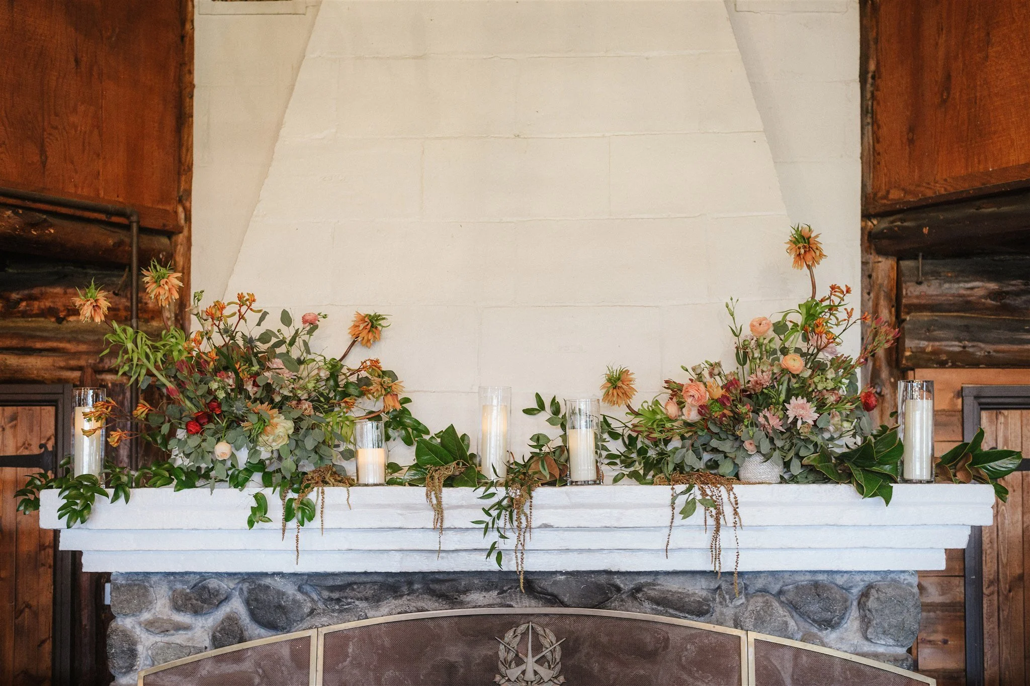 Flowers on the fireplace include anemones, roses, lilies, ranunculus. Image name: wedding-florist-boise-47
