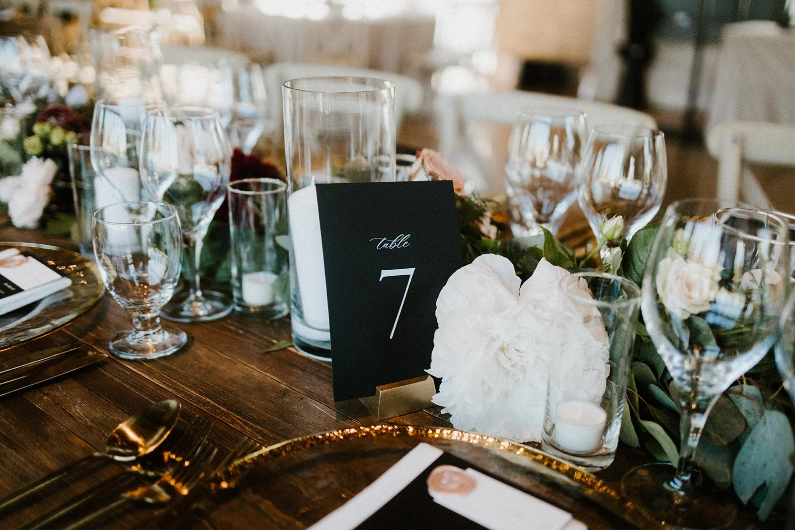 White peonies black table number wine glasses gold rim plates image name: wedding-florist-boise-212