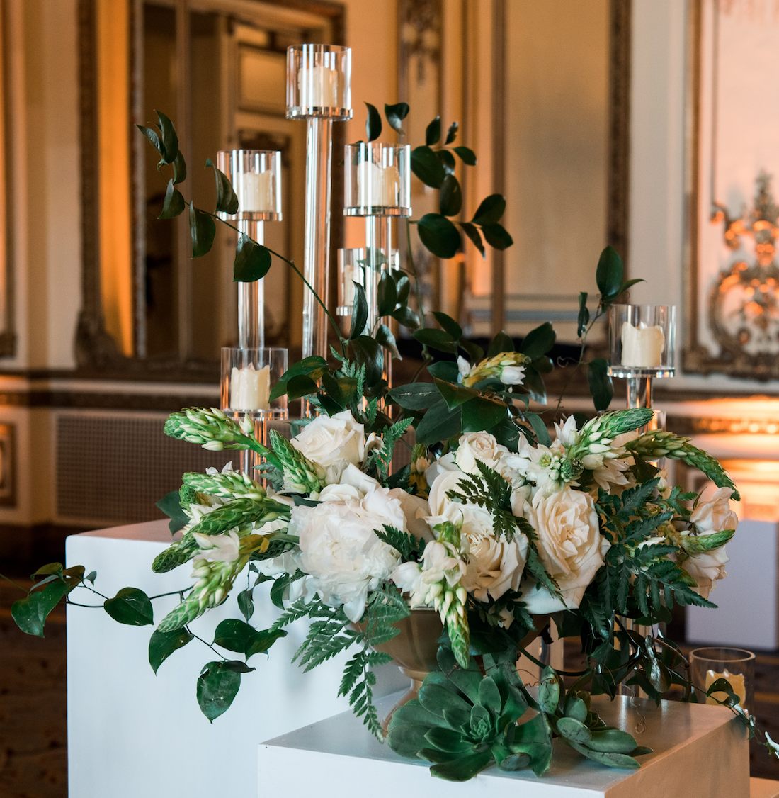 White roses green ferns next to candles in San Francisco, CA wedding image name: wedding-florist-boise-387