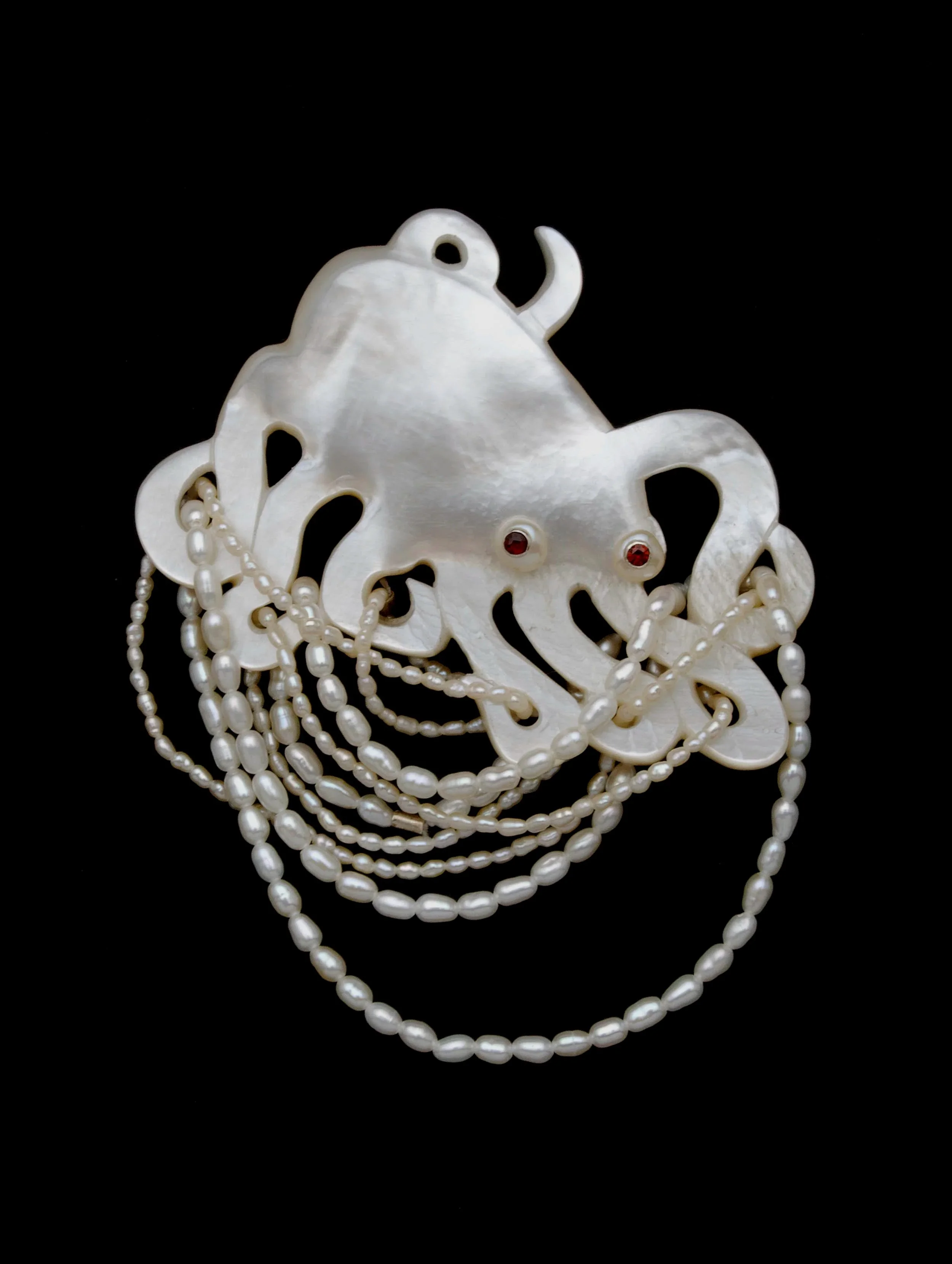 Wrestling (#1).  Mother of pearl shell, sterling silver, freshwater pearls, garnet. 2013