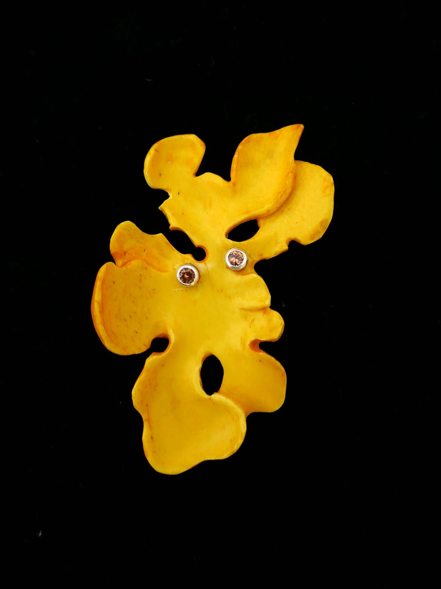 Lichen Man. Dyed bone, sterling silver,  spessartite garnets, 2024