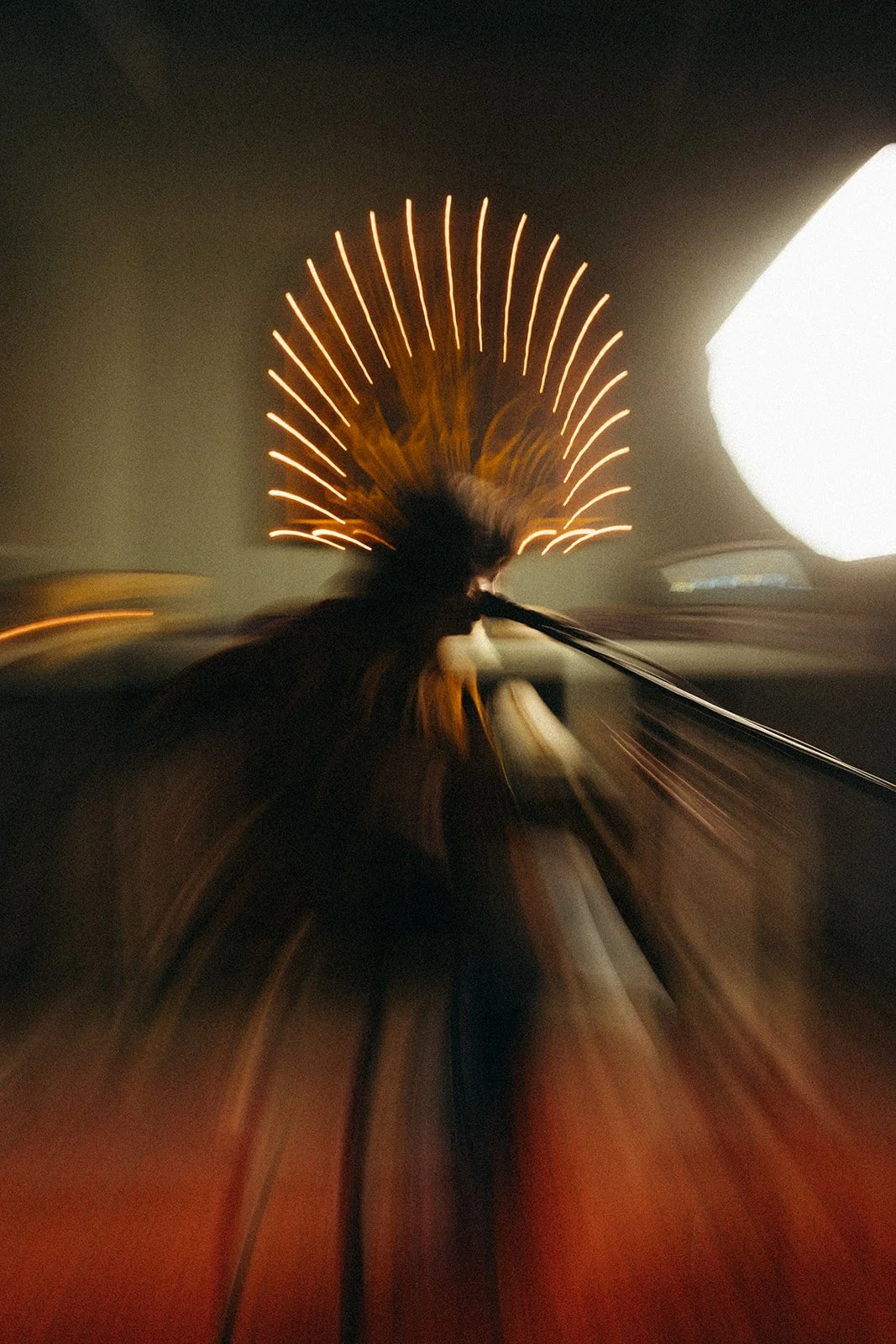 A person playing a guitar with colorful lights in the background, captured with motion blur.