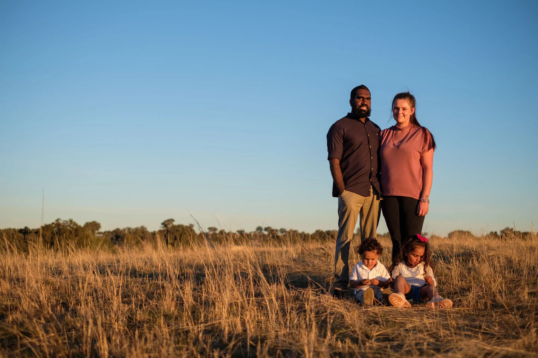 A family standing in a paddock