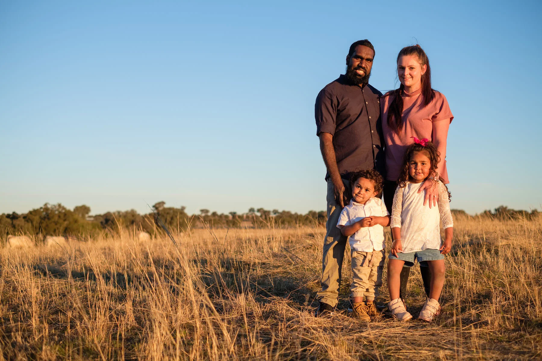 a family standing in a paddock