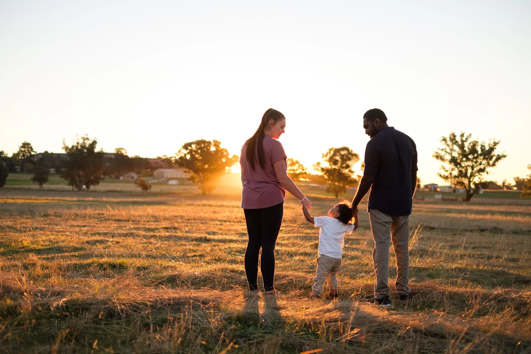 A family walking into the sunset