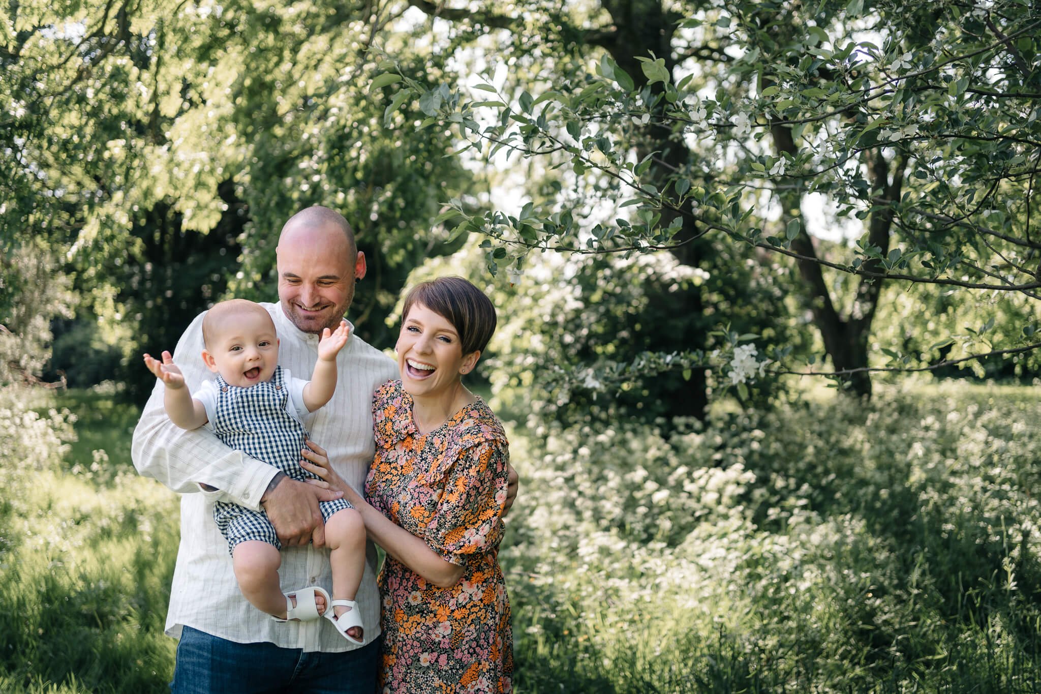 Family smiling and laughing at camera