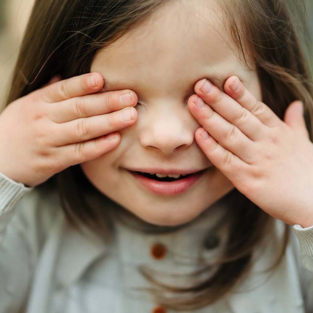 Little girl playing peekaboo