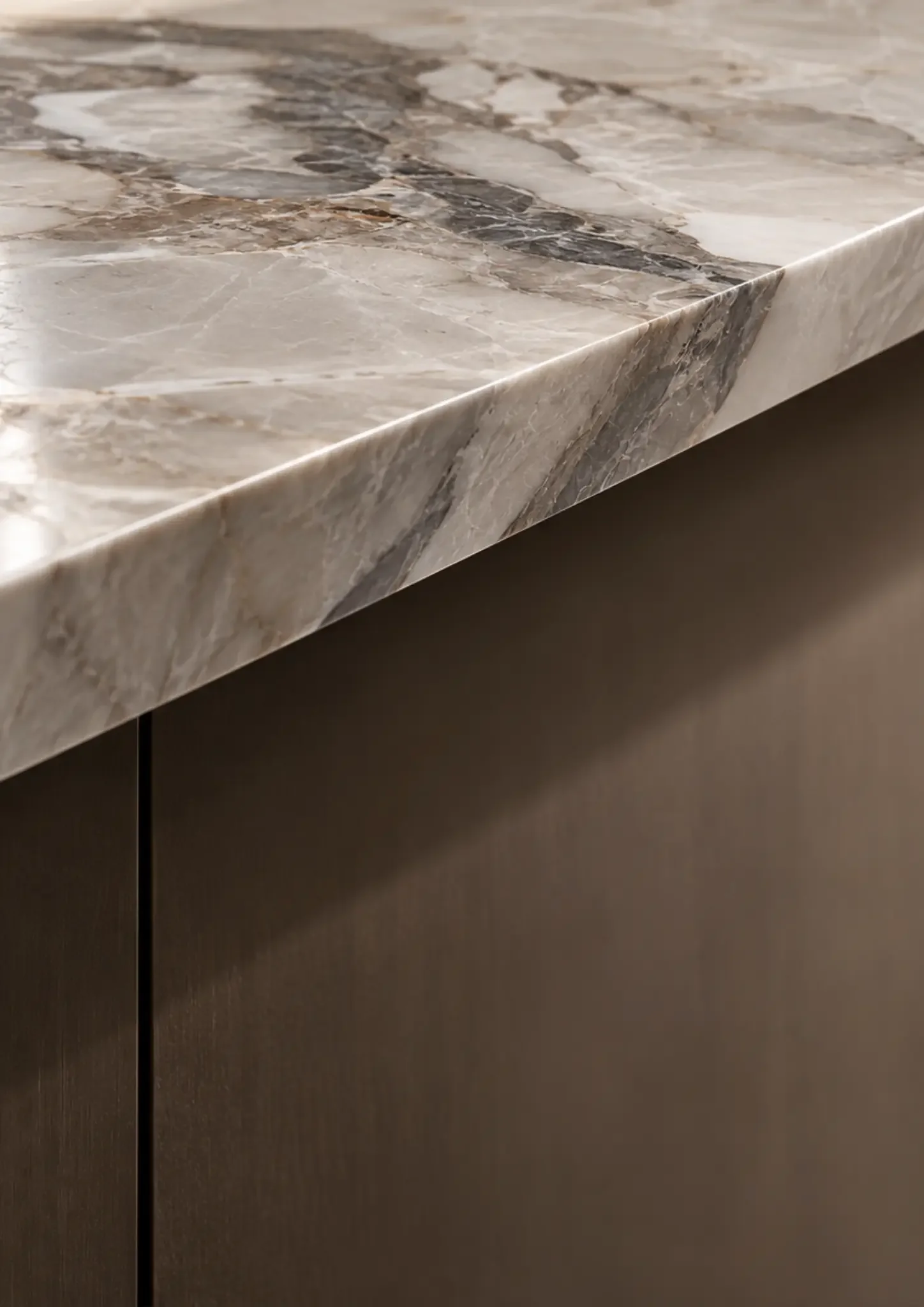 Close-up of a veined stone worktop edge above dark cabinetry