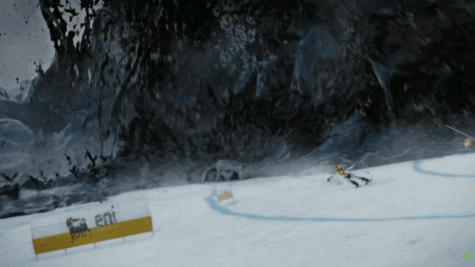 Snow-covered Olympic slope with athlete skiing while dark polluted cliff looms behind