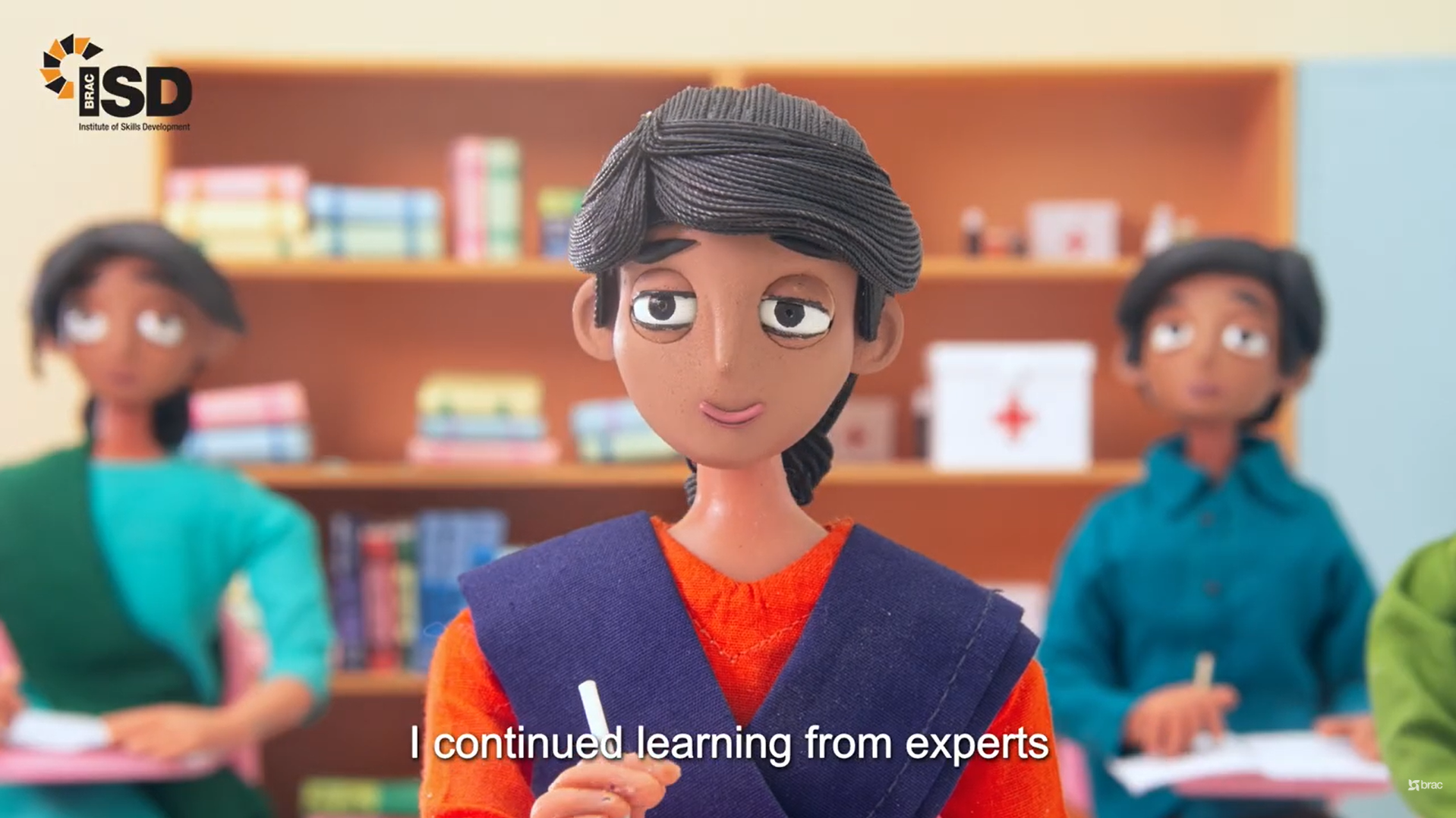 BRAC ISD stop-motion student sits in classroom while continuing her learning alongside other students.