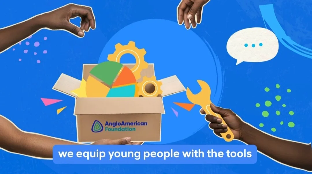 Hands offer tools from a box labeled Anglo American Foundation.