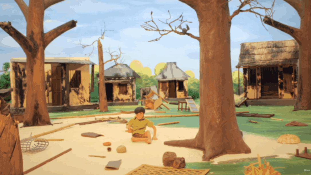 Child sitting on the ground in a rural village surrounded by damaged huts and fallen trees after a storm.