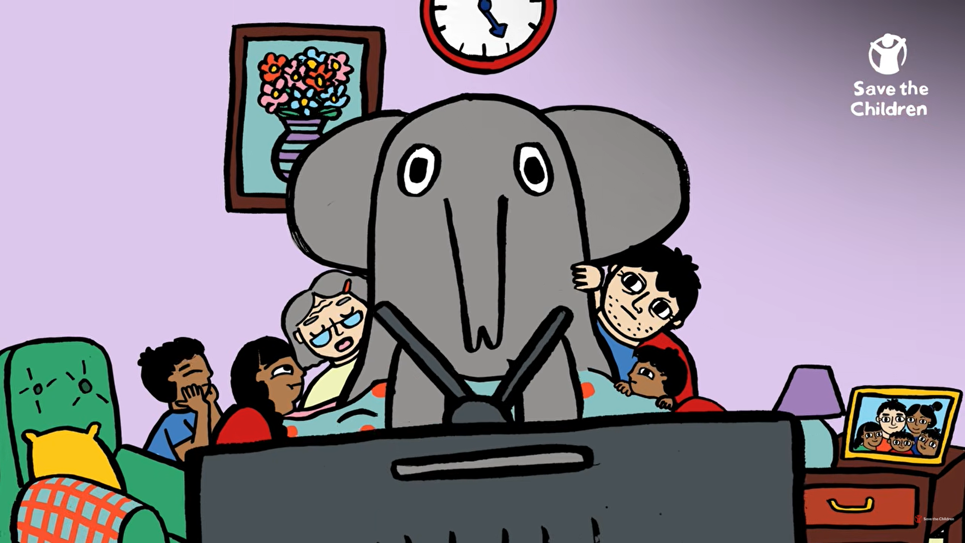 Large friendly elephant character sits with a family watching television in a Save the Children animation.