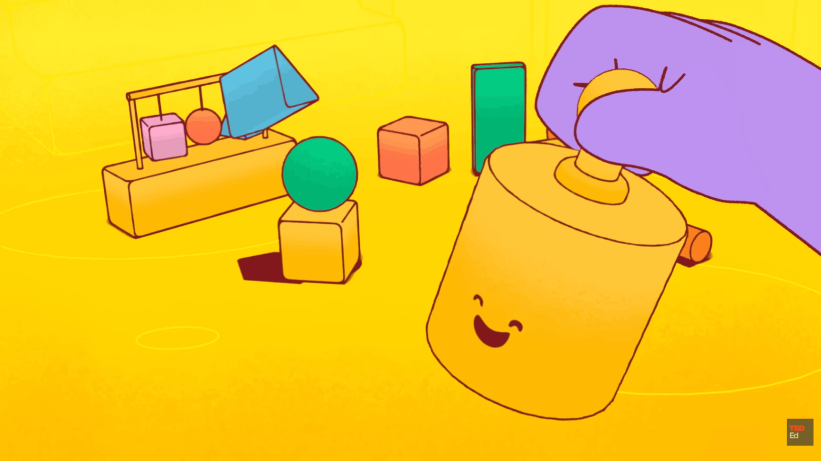 Smiling toy cylinder interacts with geometric shapes during playful early learning activity.