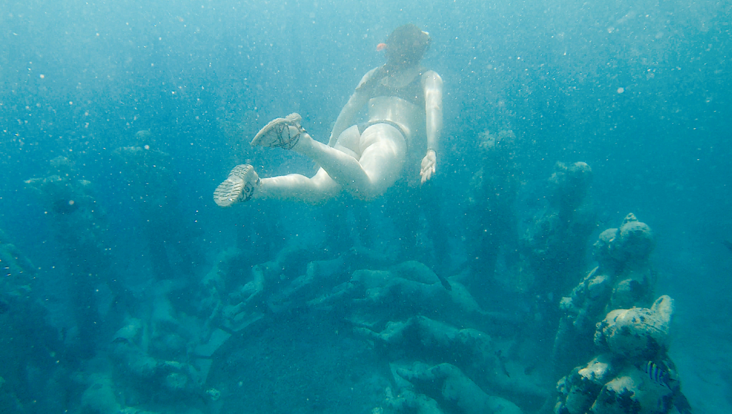 Blogger Katie Caf photographed next to the iconic underwater sculpture garden on a Gili Trawangan Snorkeling Tour. 