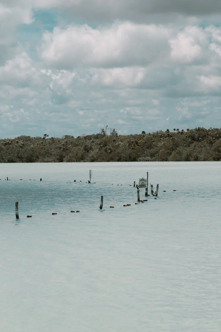 the sinkhole at laguna kaan luum which is 80 meters in depth and poses safety concerns for swimmers. 