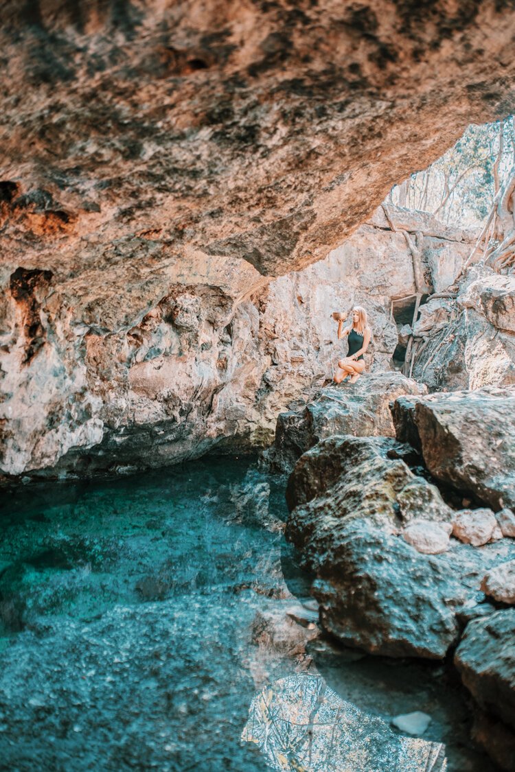 a girl at cenote aldea zama in Tulum. Cenote Aldea Zama is the only free and cenote to visit in the tulum area, but does not have any safety precautions for swimmers.