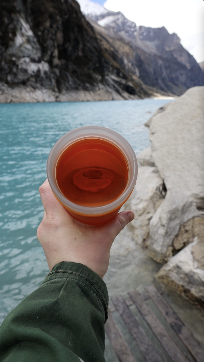 A GRAYL water filtration bottle at Laguna Paron in Peru, being used to filter the lake water to make it potable. 