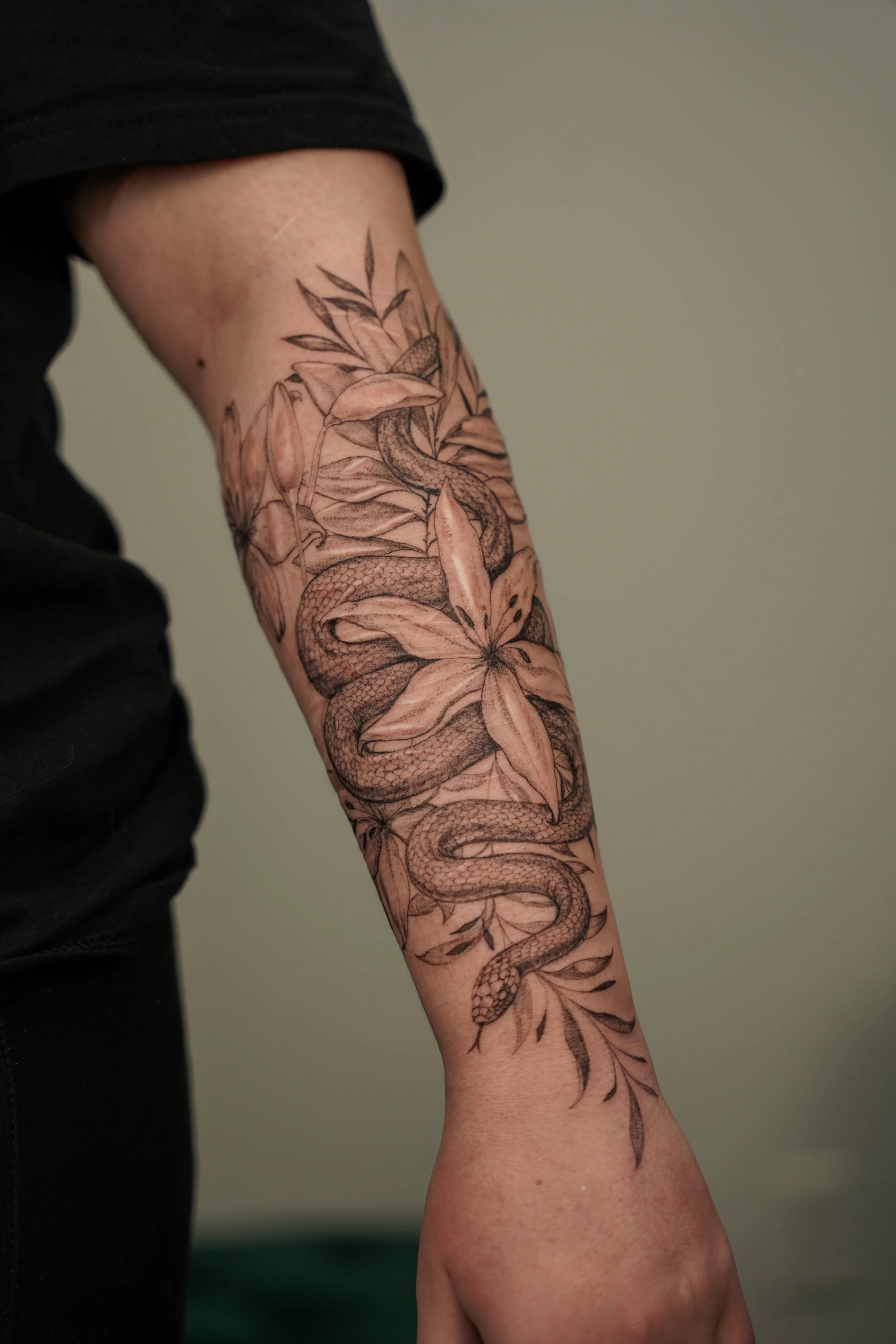 Botanical scar cover-up tattoo designed around the natural direction of the scars