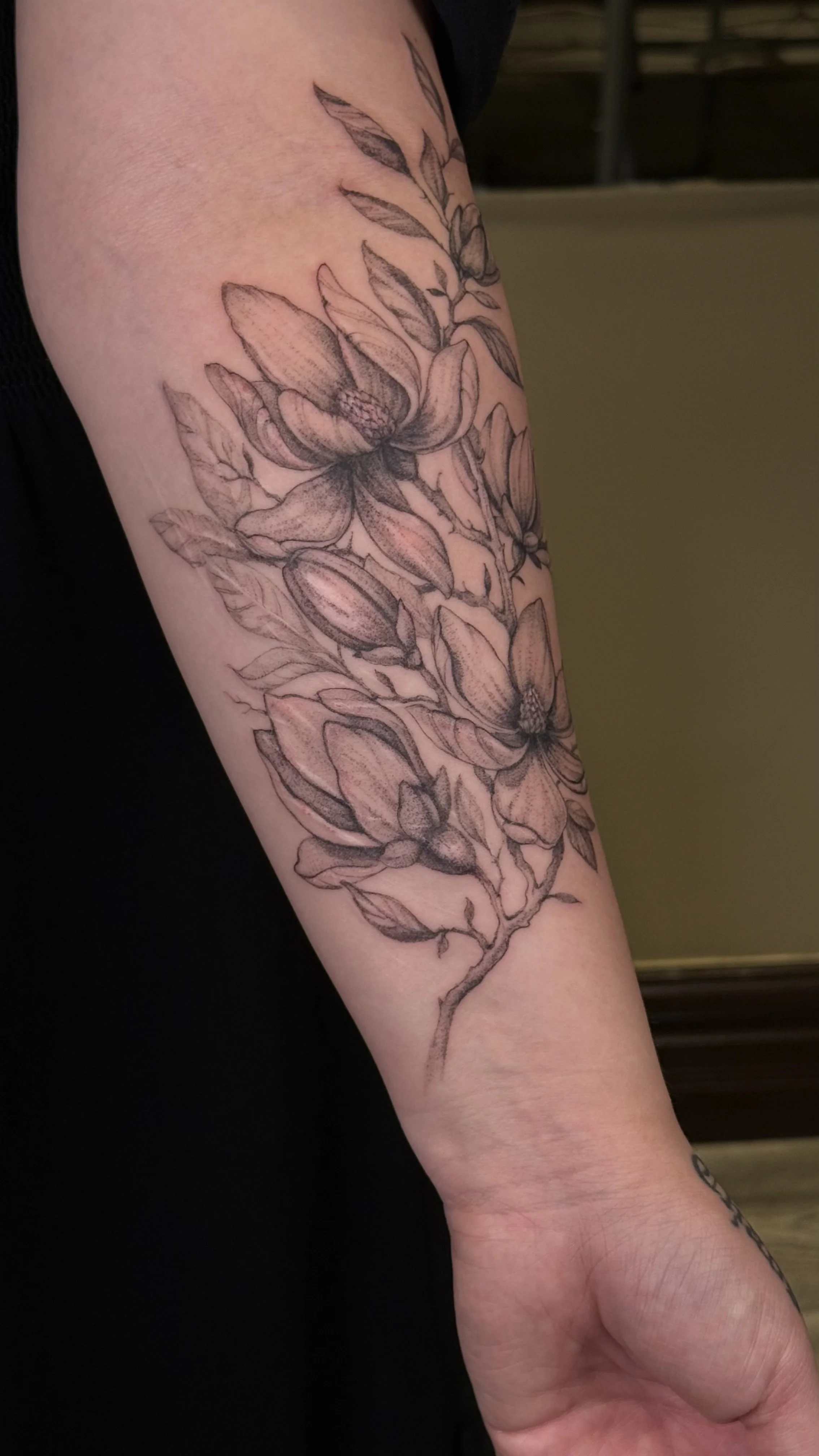 Finished fine line botanical scar cover-up tattoo on the forearm.