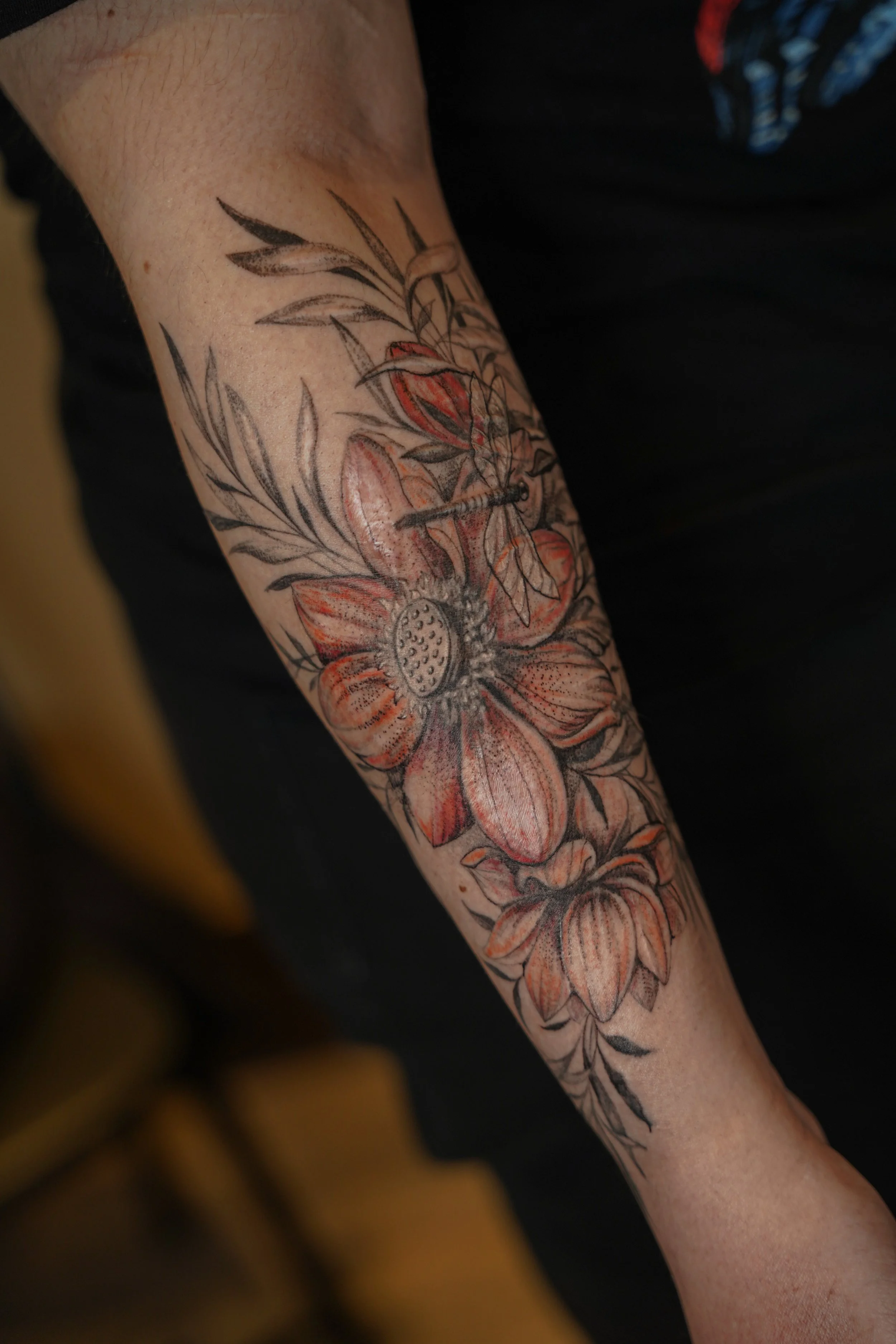 Floral scar cover-up tattoo on the forearm