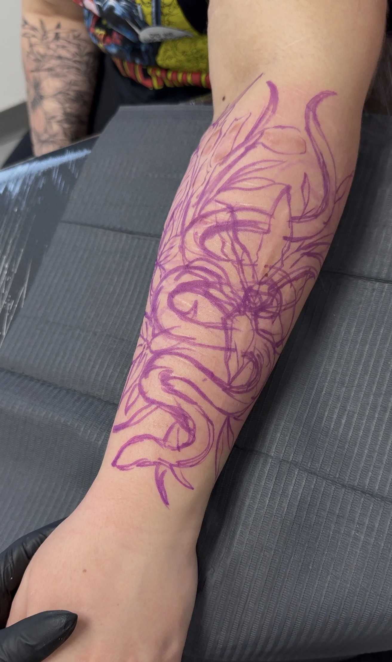 Custom floral tattoo design placed to follow the direction of the scars