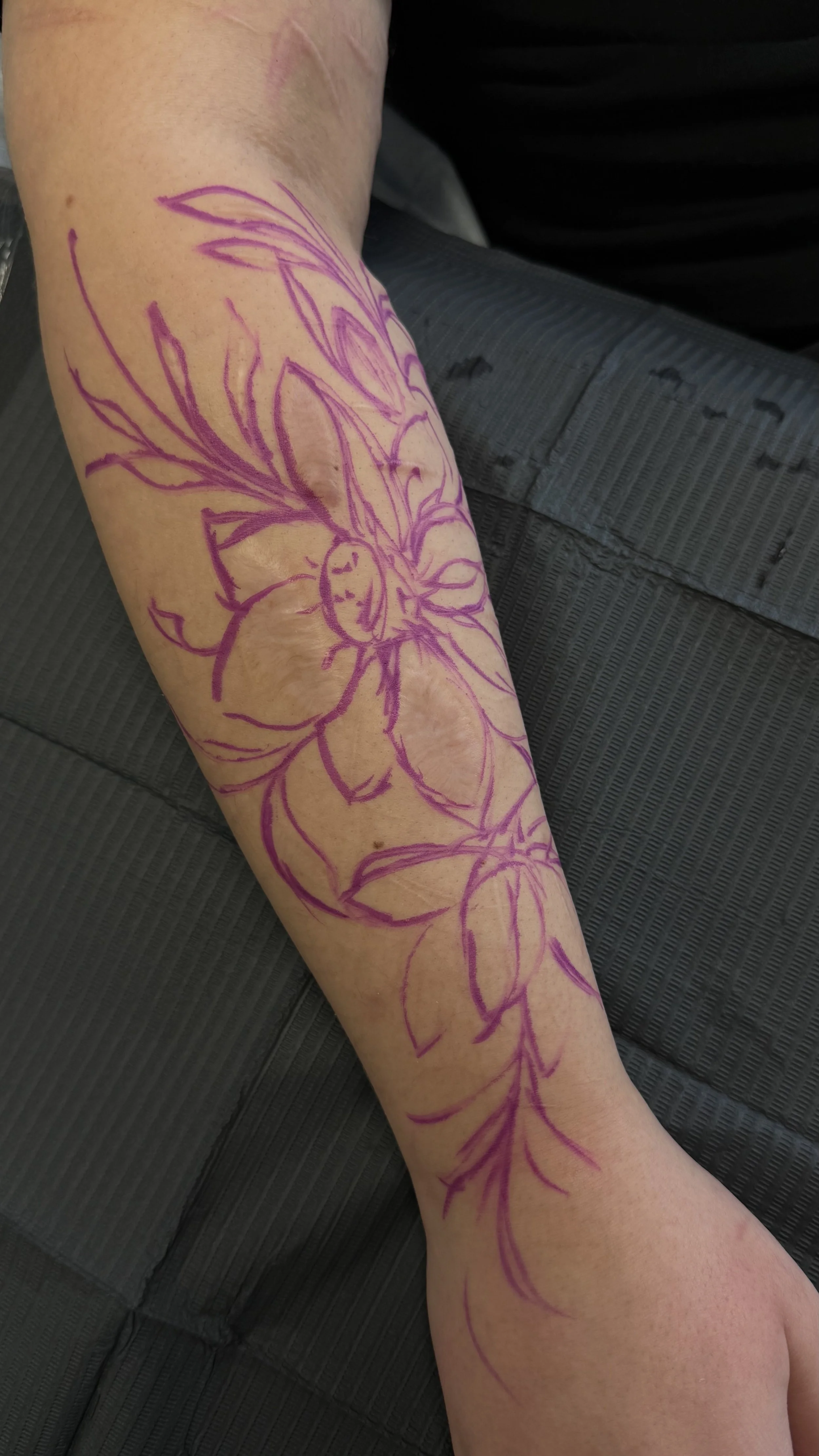 Custom botanical stencil designed to follow the direction of scars on the forearm.